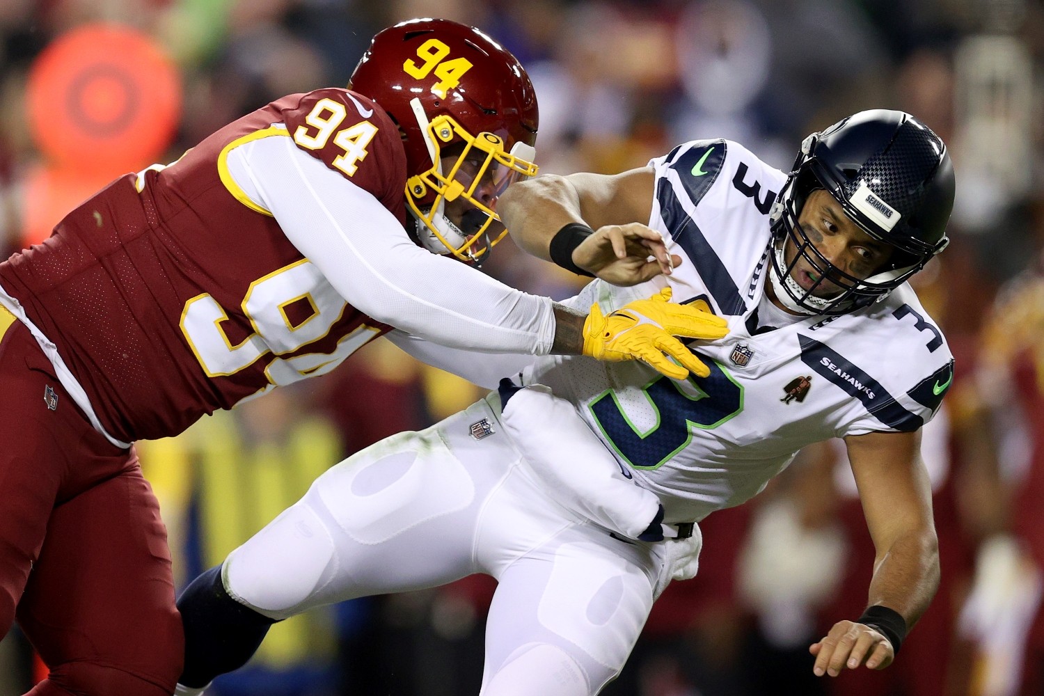 Washington Football Team defensive lineman Daron Payne sacks Seattle Seahawks QB Russell Wilson.