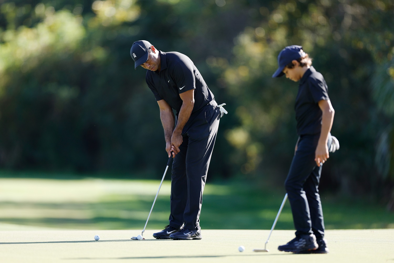 Tiger Woods and son Charlie during the pro-am ahead of the PNC Championship at the Ritz-Carlton Golf Club Grande Lakes on Dec. 17, 2021, in Orlando, Florida.