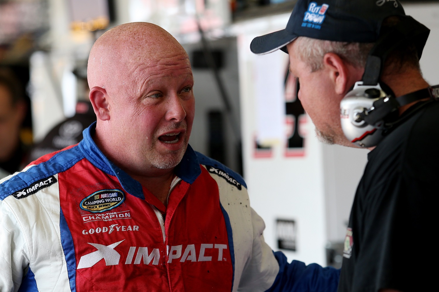 Todd Bodine talks with a crew member during practice for the NASCAR Xfinity Series VFW Sport Clips Help A Hero 200 at Darlington Raceway on Sept. 4, 2015. | Matt Hazlett/Getty Images
