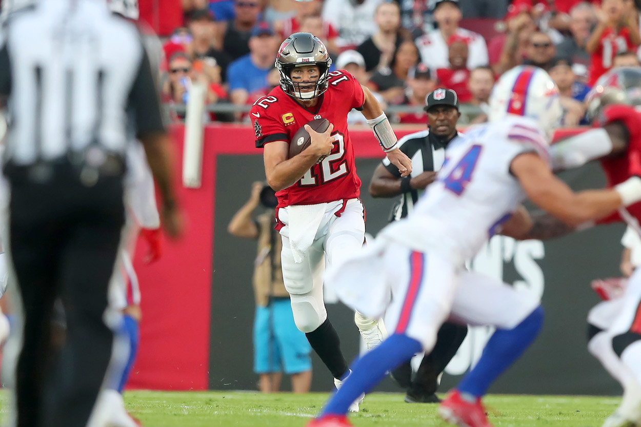 Tampa Bay Buccaneers Quarterback Tom Brady, who called out Tony Romo and Peyton Manning on Monday, runs the ball during the regular season game between the Buffalo Bills and the Tampa Bay Buccaneers on December 12, 2021 at Raymond James Stadium in Tampa, Florida.