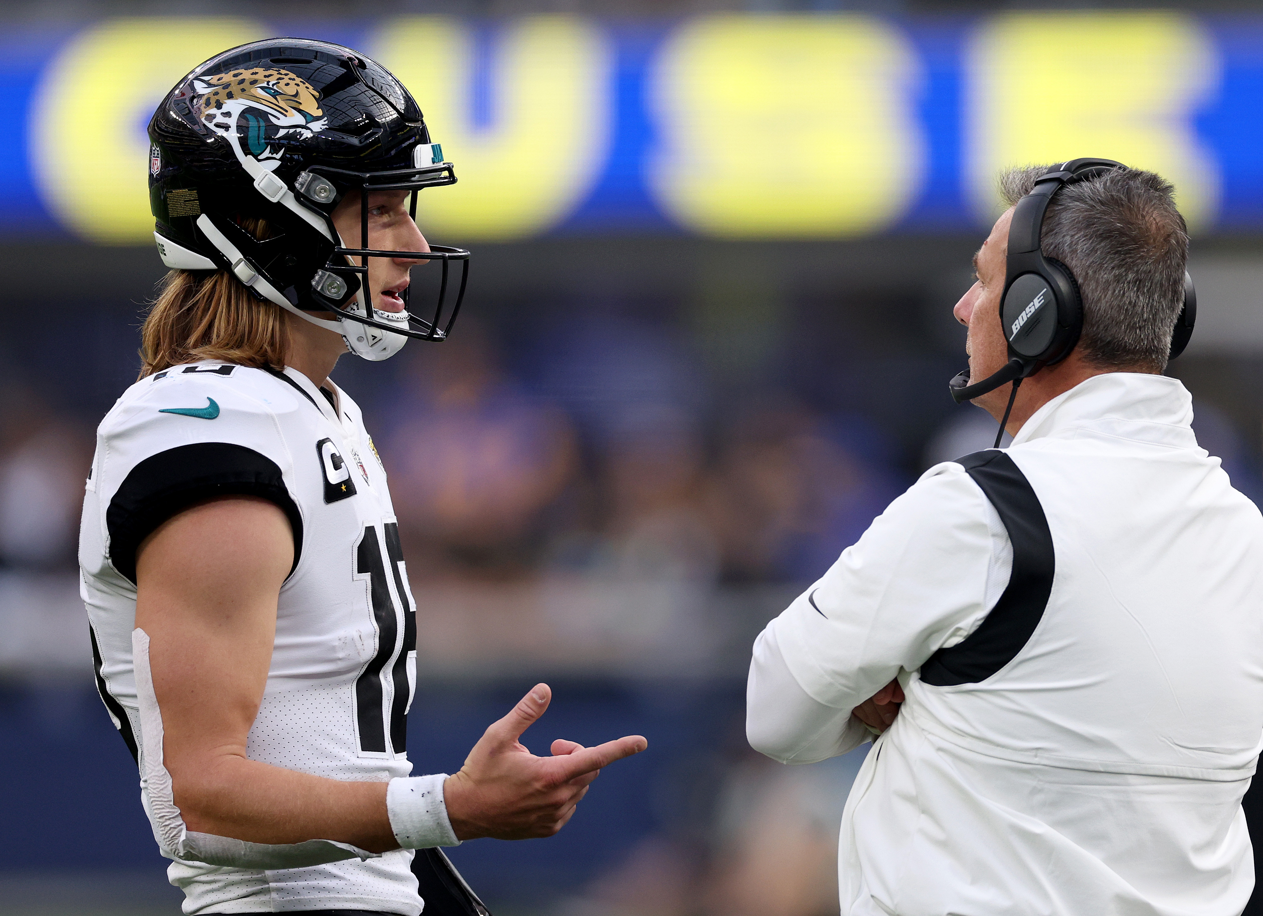 Jaguars quarterback Trevor Lawrence talks to head coach Urban Meyer