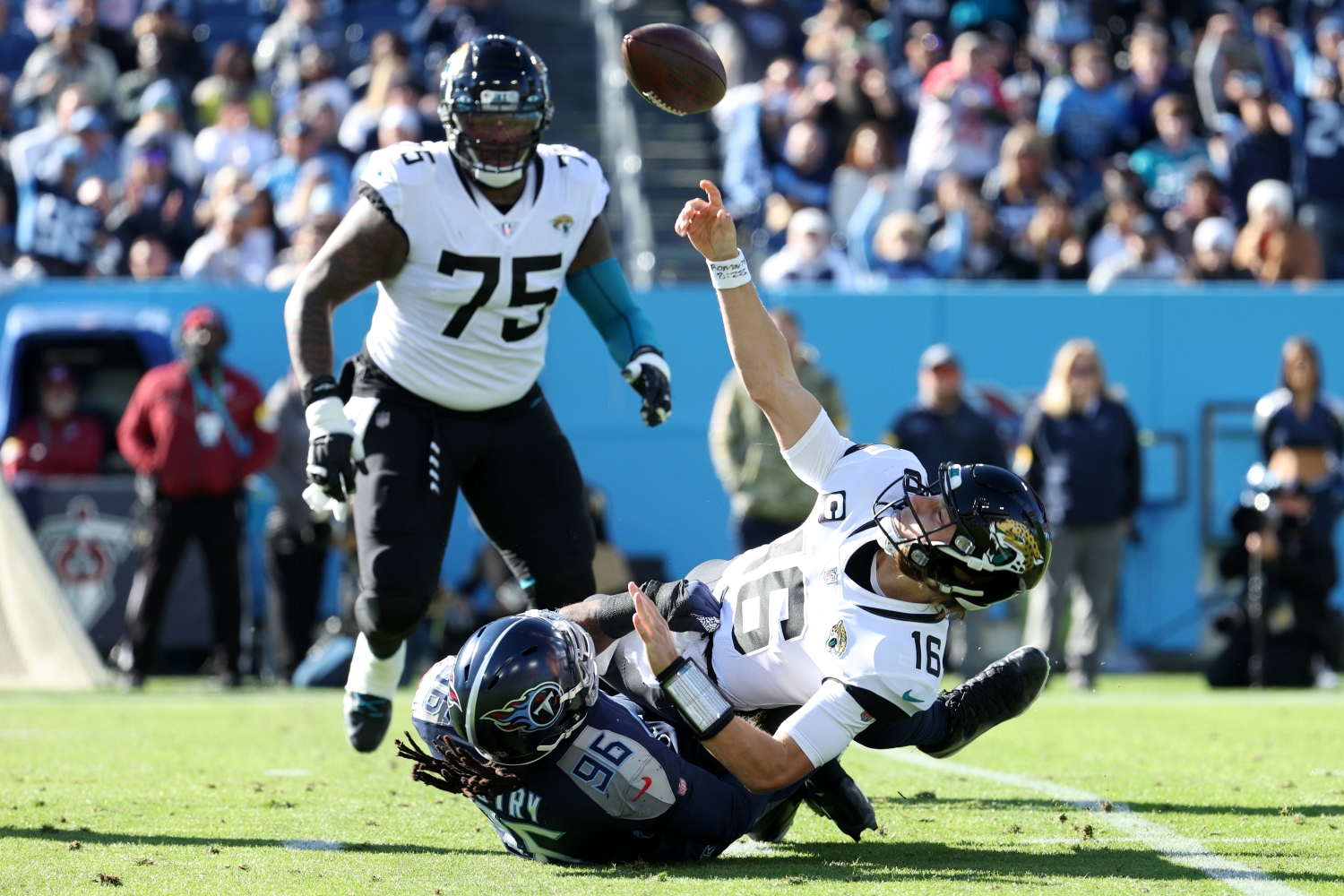 Jaguars QB Trevor Lawrence gets sacked by a Tennessee Titans defender while attempting to get rid of the ball.