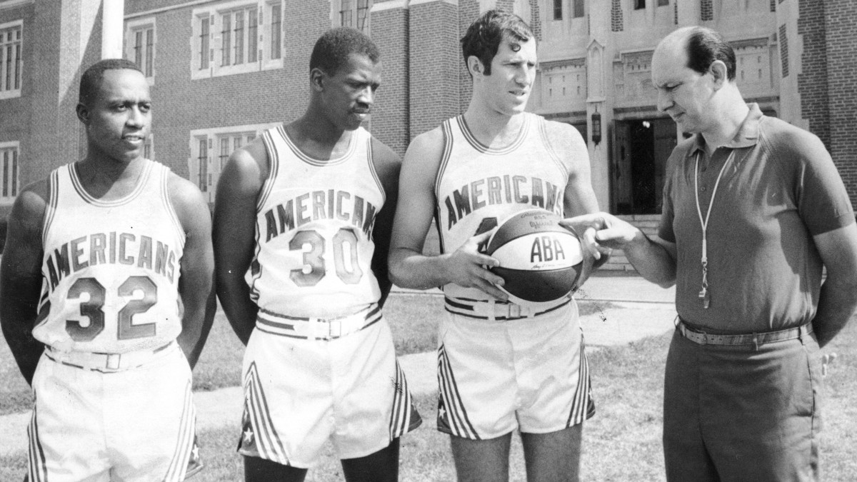 Members of the original New Jersey Americans show off an ABA basketball outside the Teaneck Armory. The franchise is now known as the Brooklyn Nets.
