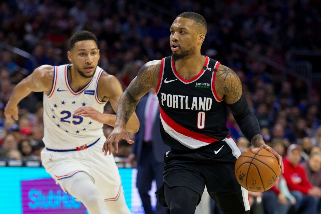 Ben Simmons of the Philadelphia 76ers, who remains in the trade rumor mill, defends Damian Lillard of the Portland Trail Blazers.