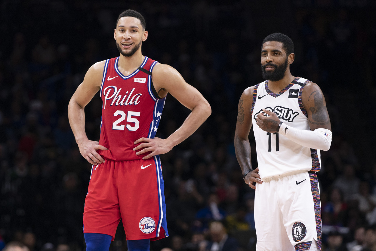 Ben Simmons and Kyrie Irving stand side by side during a game.