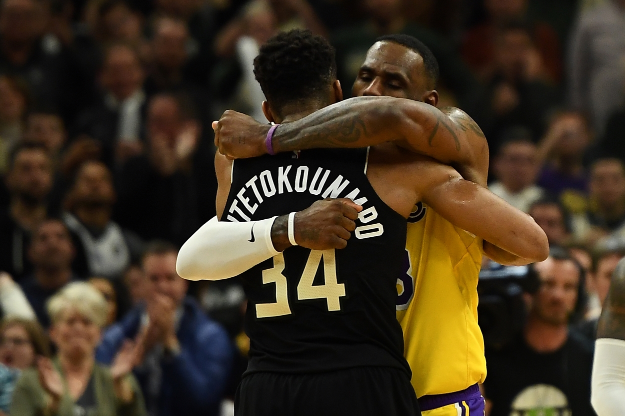 Giannis Antetokounmpo of the Milwaukee Bucks and LeBron James of the Los Angeles Lakers hug after a game.