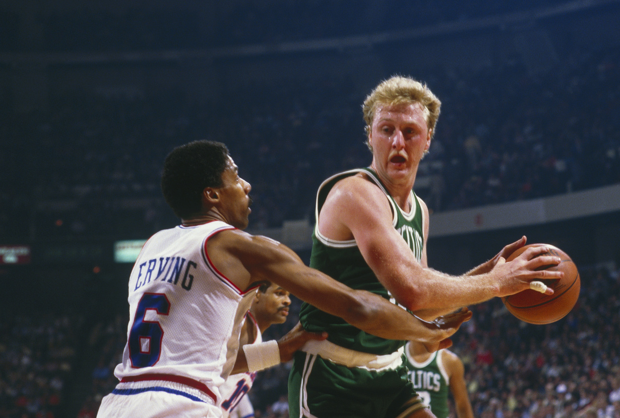 Larry Bird backs down Julius Erving during a game.