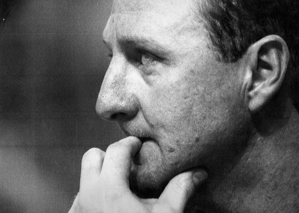Larry Bird of the Boston Celtics looks on from the bench.