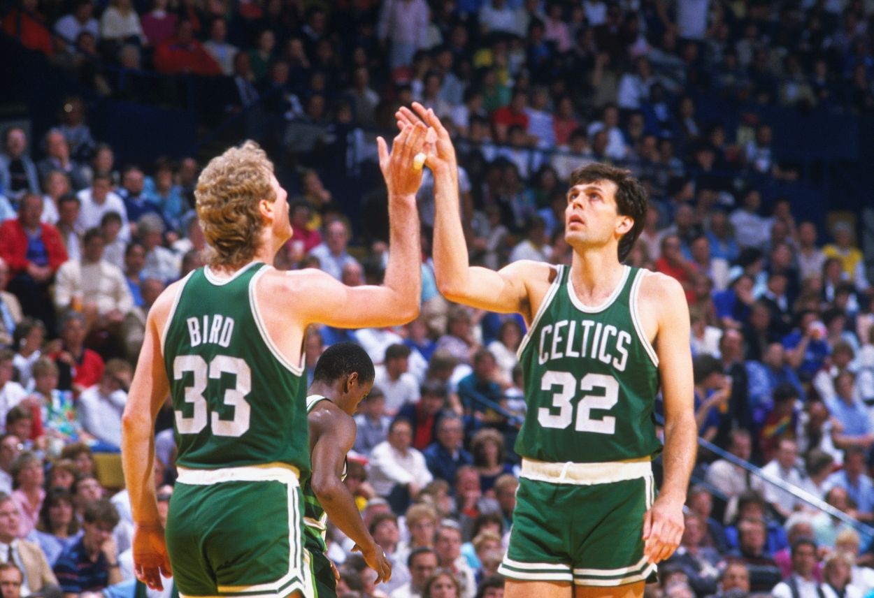Boston Celtics forwards Larry Bird and Kevin McHale high five.