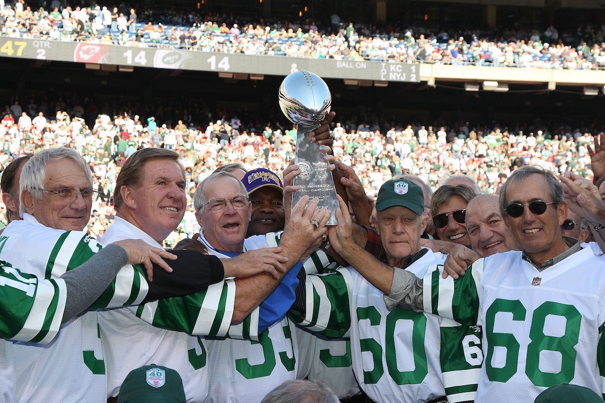 The 1968 New York Jets hold the Super Bowl trophy during a 2008 halftime ceremony honoring the Super Bowl III team