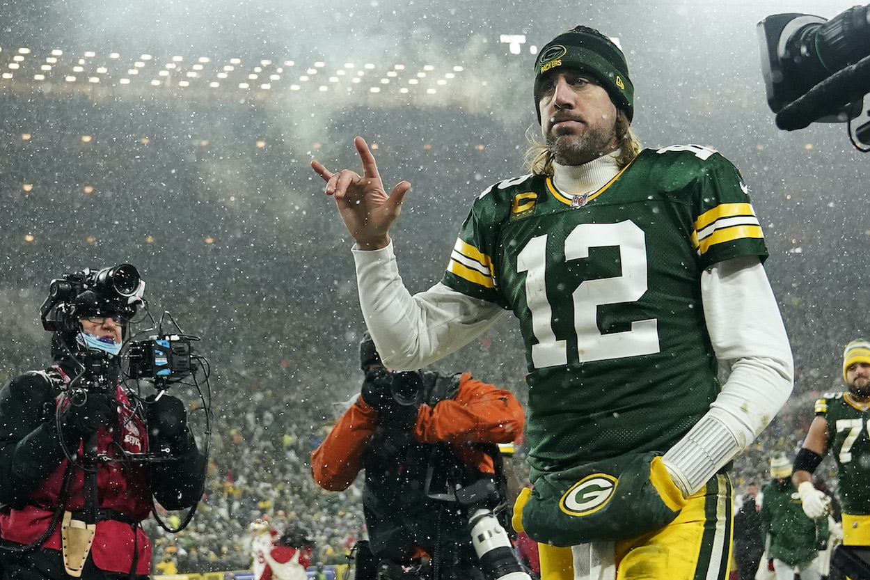 Quarterback Aaron Rodgers of the Green Bay Packers gestures as he exits the field after losing the NFC Divisional Playoff game to the San Francisco 49ers at Lambeau Field on January 22, 2022 in Green Bay, Wisconsin.
