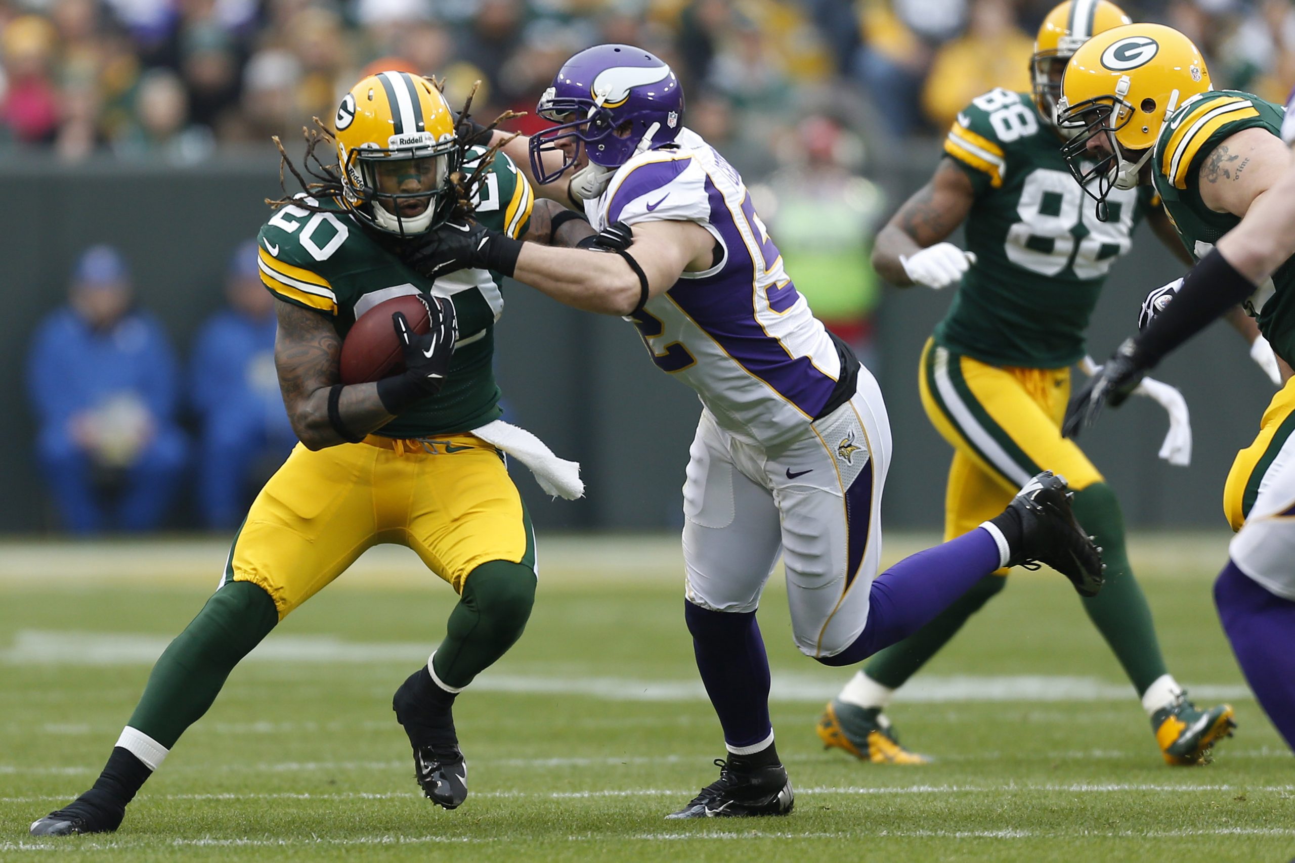 Alex Green of the Green Bay Packers runs the ball against the Minnesota Vikings.