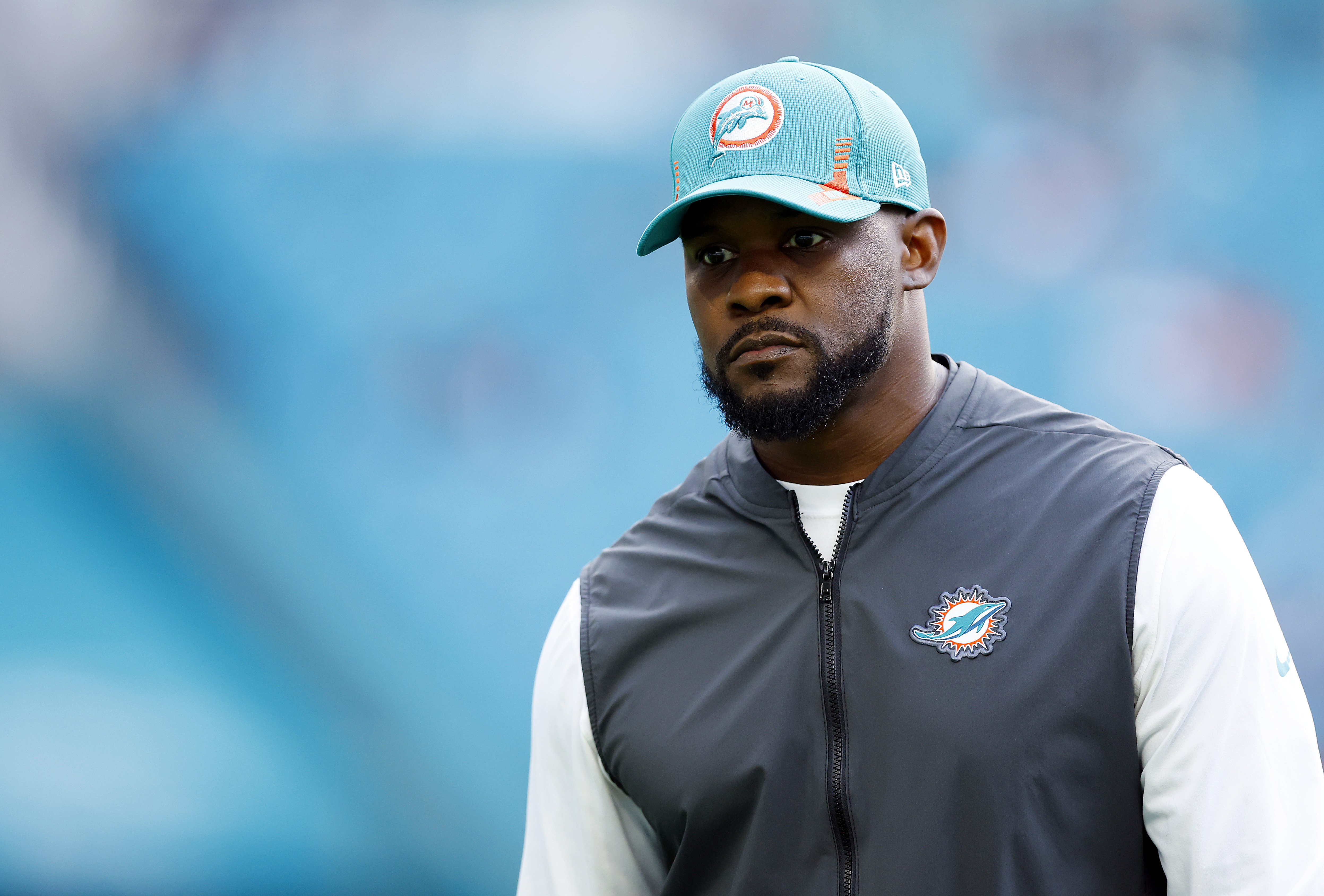 Former Dolphins head coach Brian Flores looks on before a game