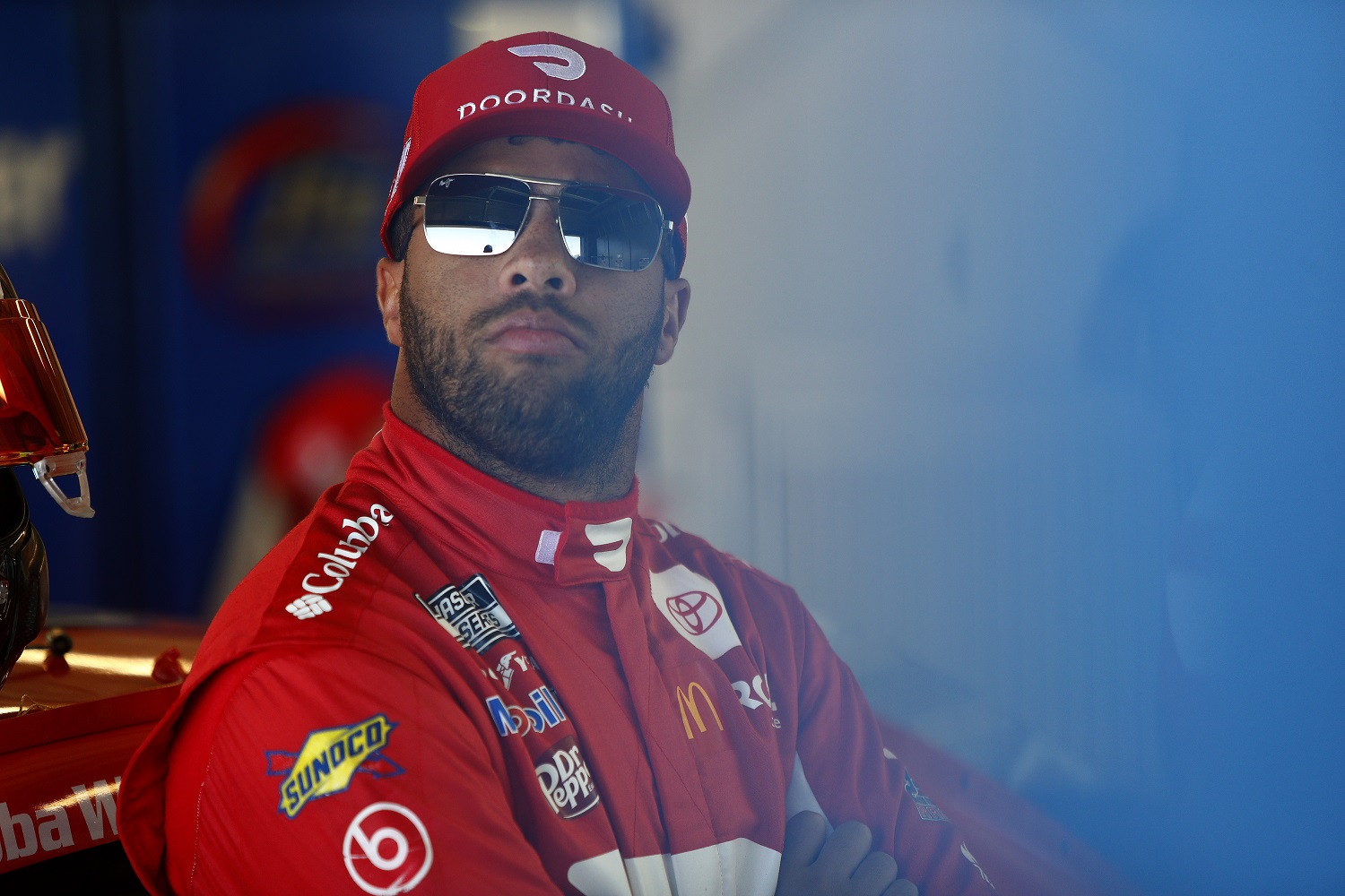 Bubba Wallace, driver of the No. 23 Toyota, waits in the garage area during practice for the NASCAR Cup Series Championship at Phoenix Raceway on Nov. 5, 2021.