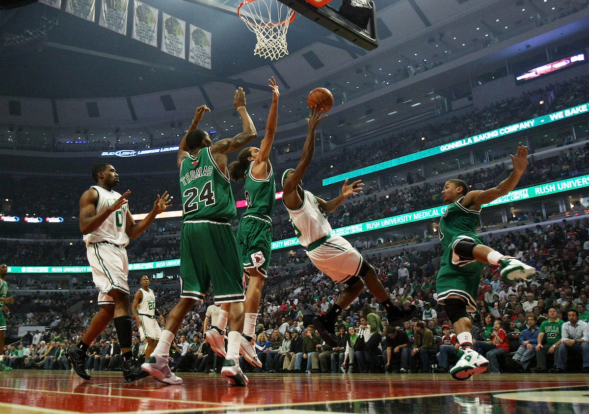 Rajon Rondo of the Boston Celtics puts up a shot against Tyrus Thomas, Joakim Noah, and Derrick Rose of the Chicago Bulls during the 2009 NBA Playoffs
