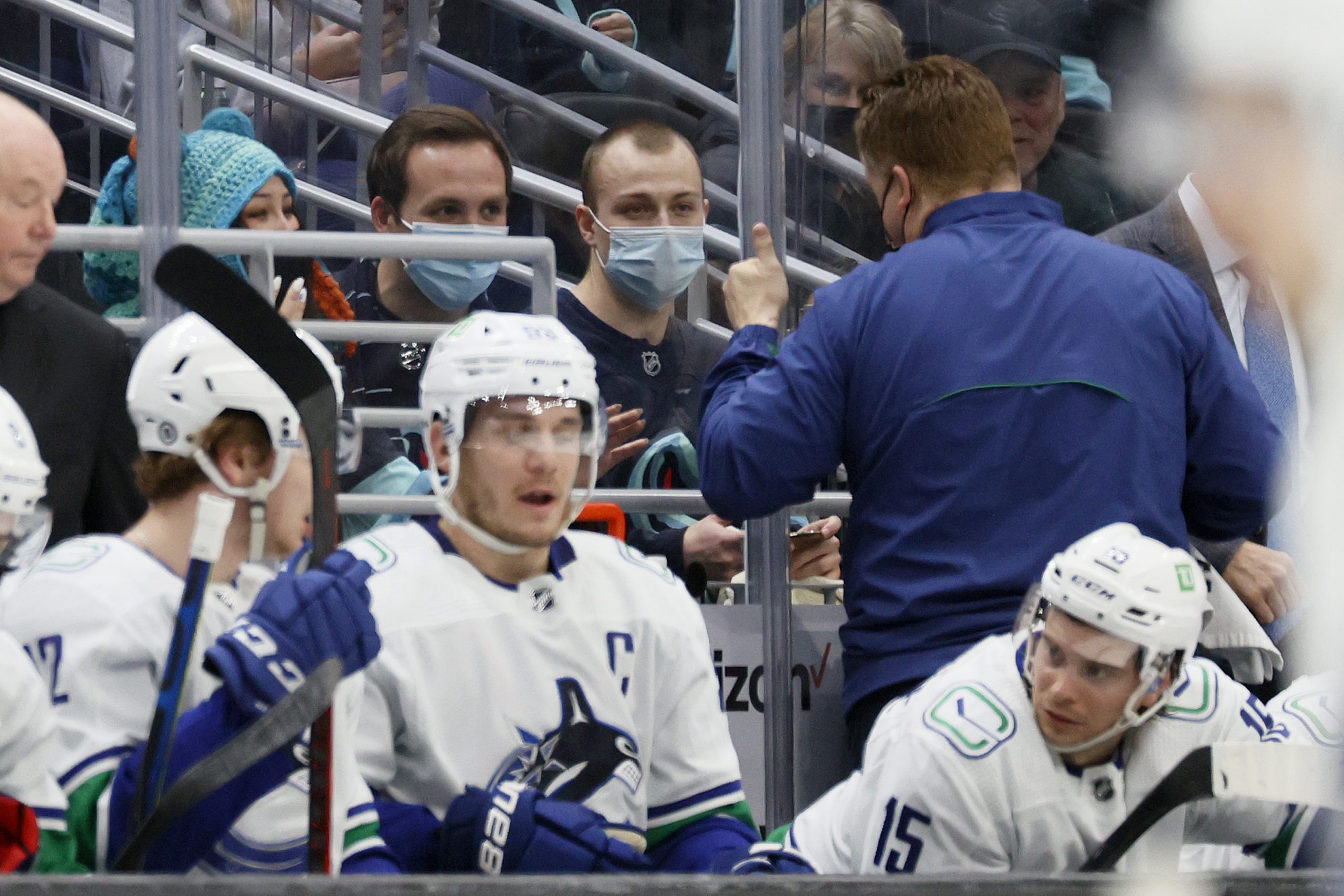 Seattle Kraken fan Nadia Popovici and Vancouver Canucks equipment manager Brian Hamilton greet one another.