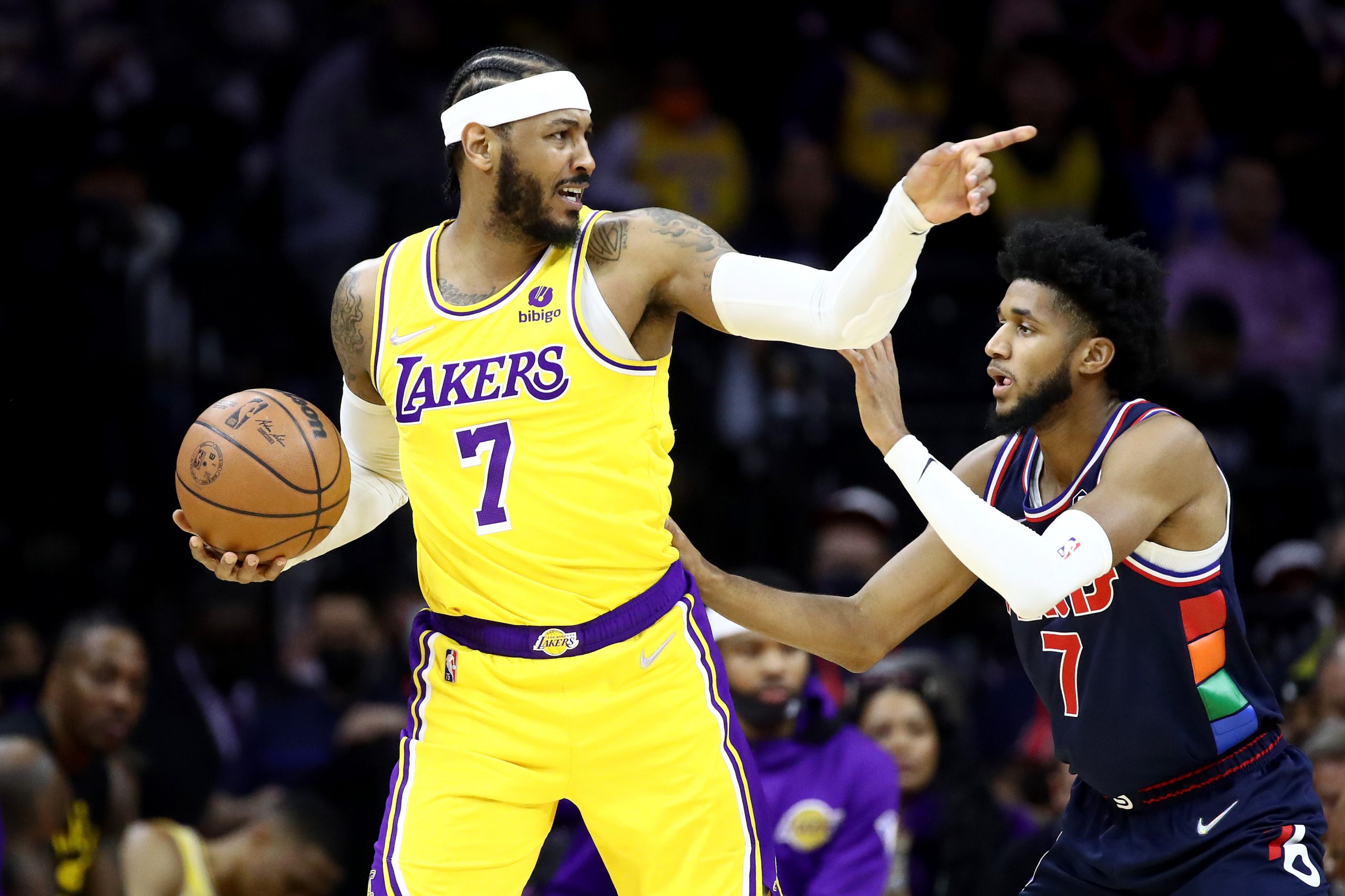 Los Angeles Lakers forward Carmelo Anthony directs traffic while being guarded by Philadelphia 76ers forward Isaiah Joe during a game at Wells Fargo Center on January 27, 2022.