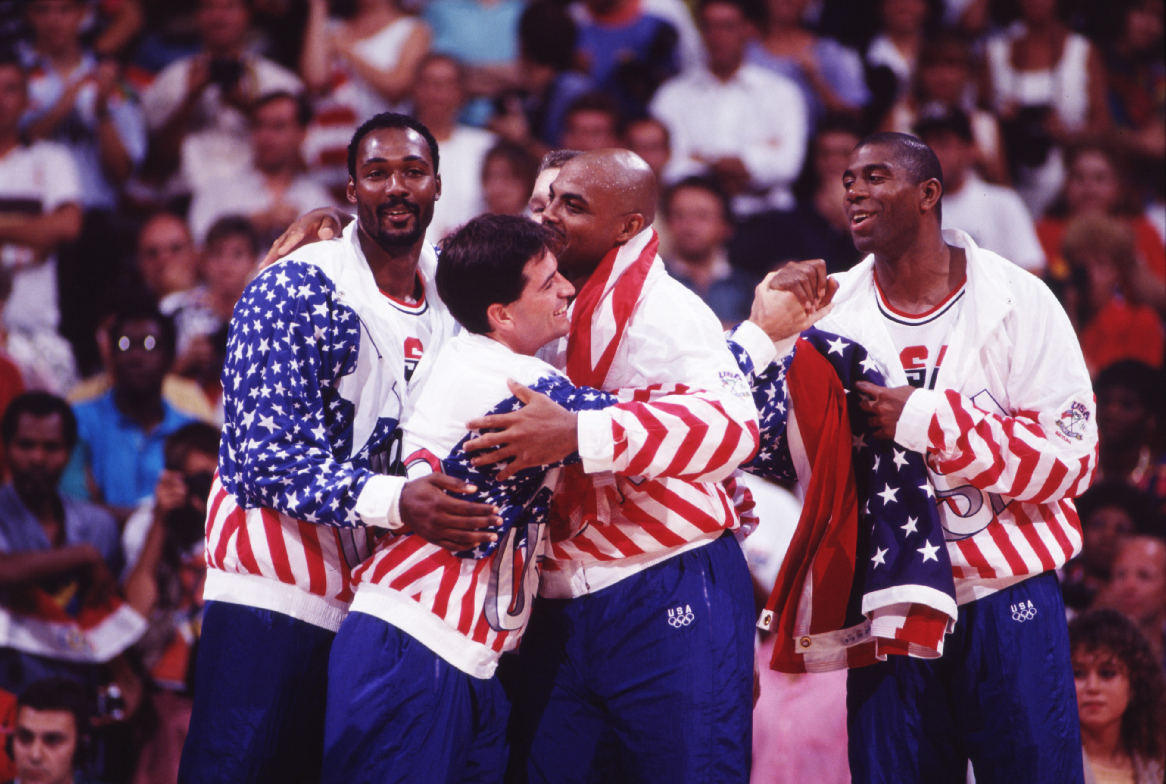 Charles Barkley and John Stockton embrace as the Dream Team prepares to receive gold medals at the 1992 Olympic Games in Barcelona