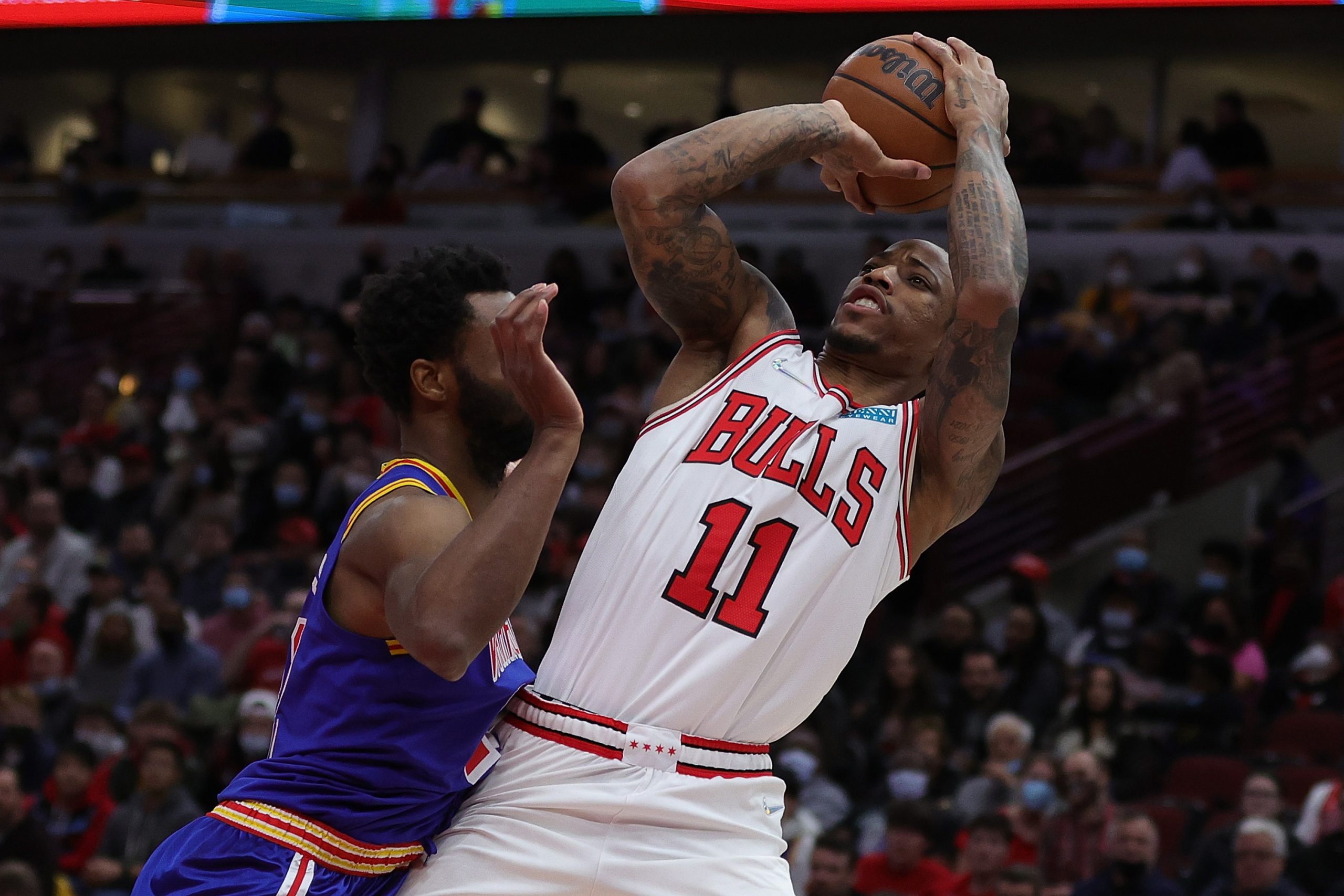 Chicago Bulls star guard DeMar DeRozan is fouled by Golden State forward Andrew Wiggins in a recent game at United Center.