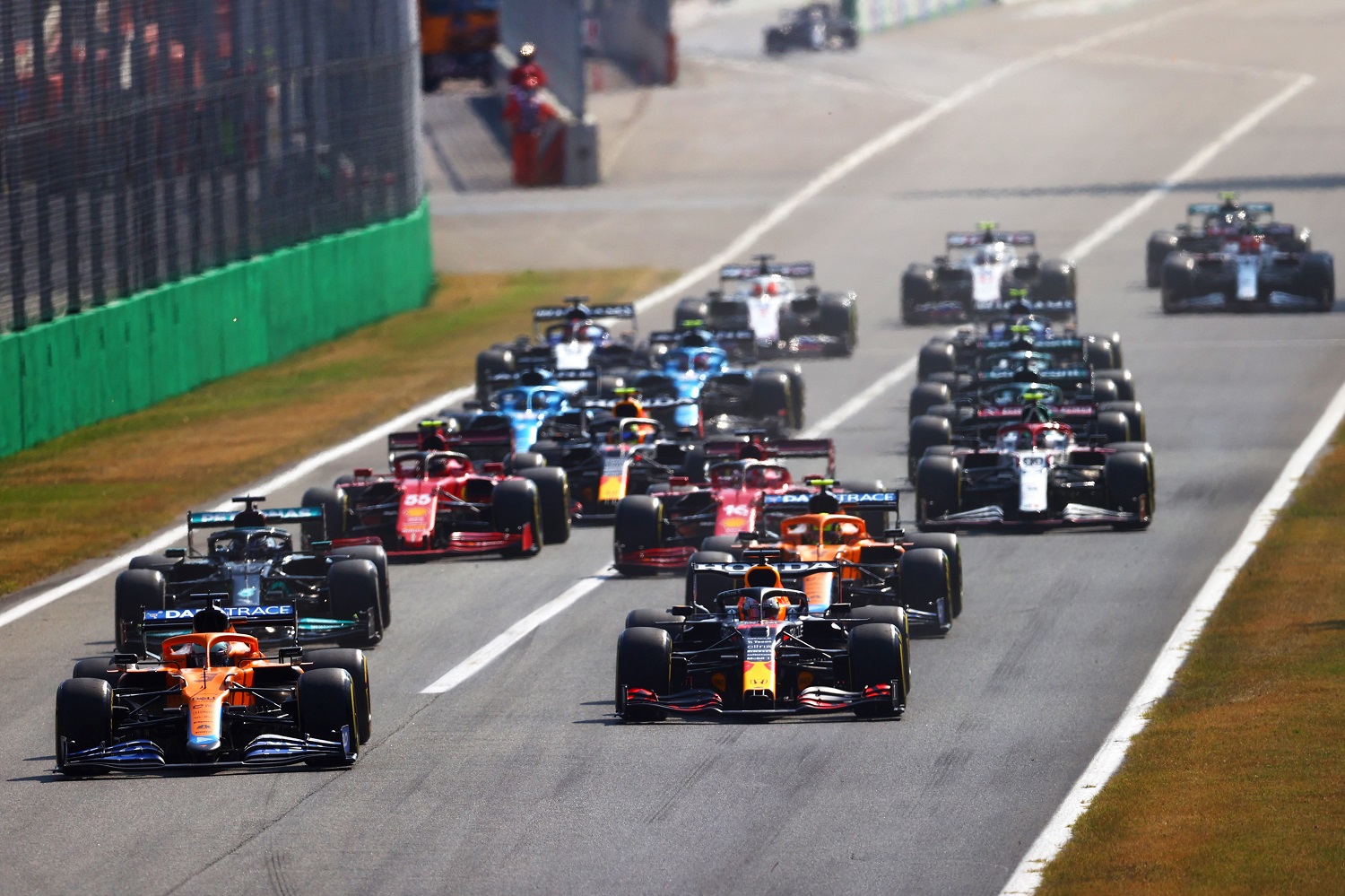 Daniel Ricciardo leads Max Verstappen into the first corner at the start of the Formula 1 Grand Prix of Italy at Autodromo di Monza on Sept. 12, 2021 in Monza, Italy. | Dan Istitene - Formula 1/Formula 1 via Getty Images