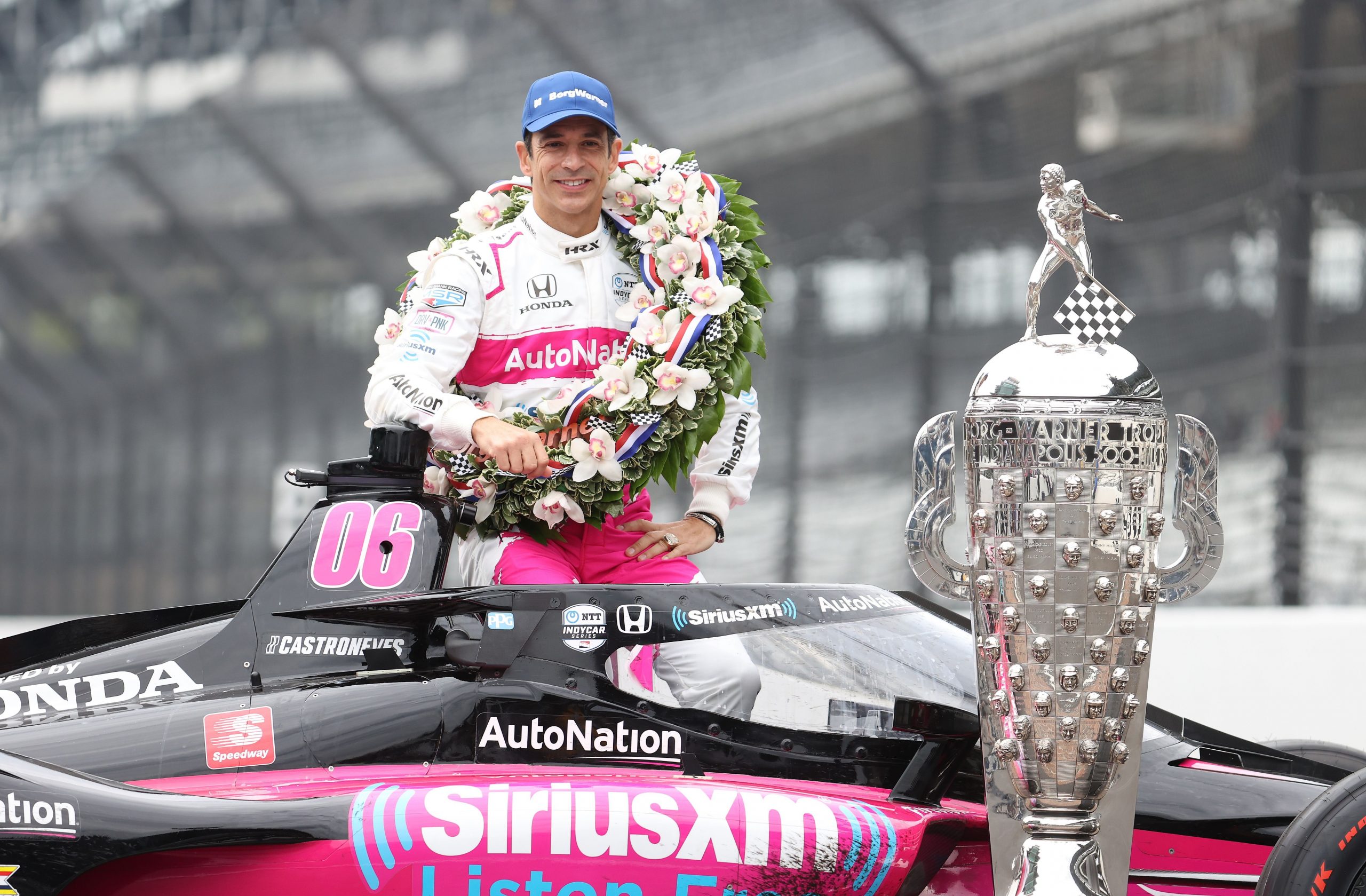 Helio Castroneves poses with trophy