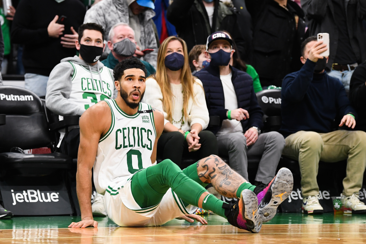 Jayson Tatum of the Boston Celtics sits on the floor as his last-second shot misses.