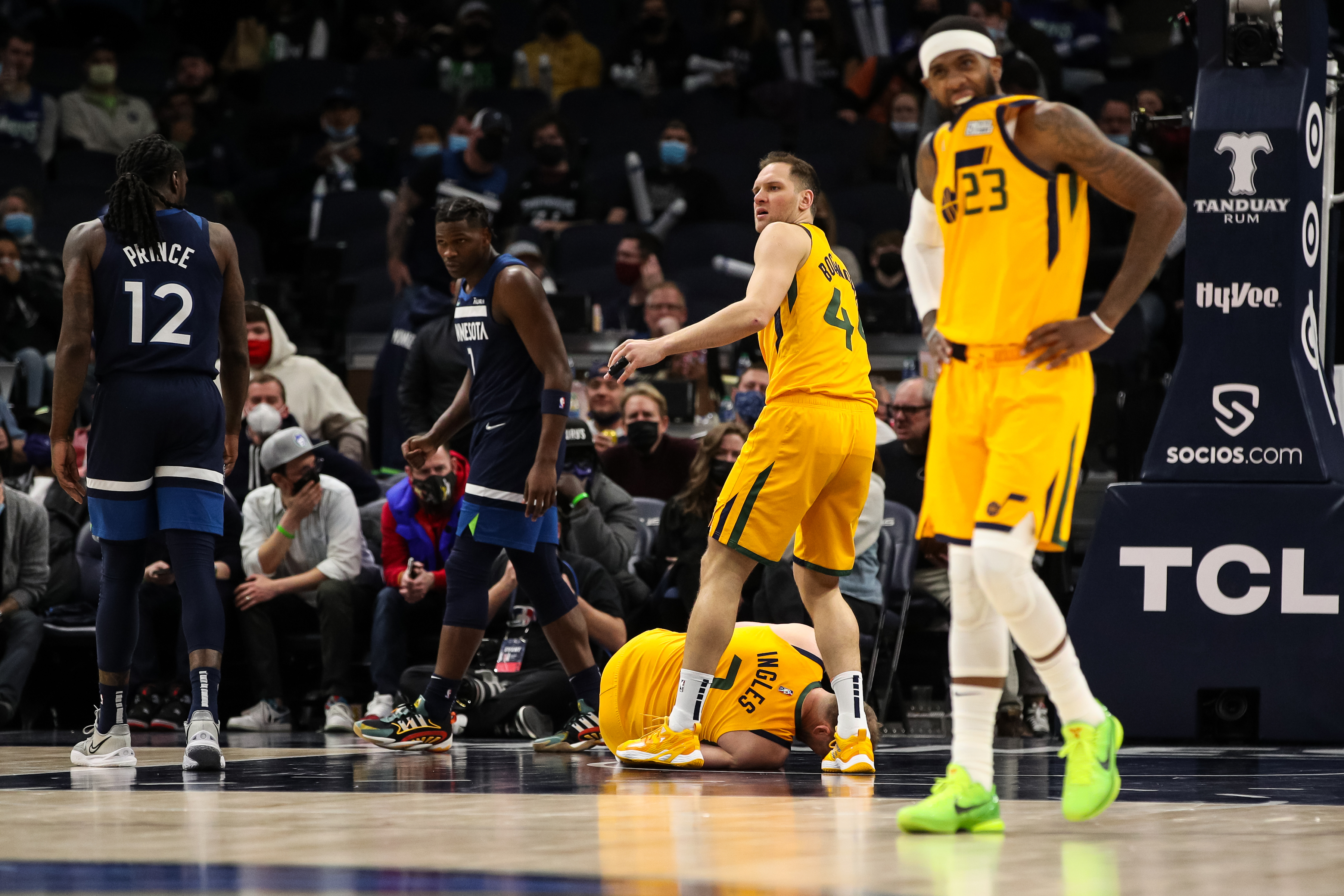 Utah Jazz forward Joe Ingles lies on the floor after suffering a knee injury during an NBA game against the Minnesota TImberwolves
