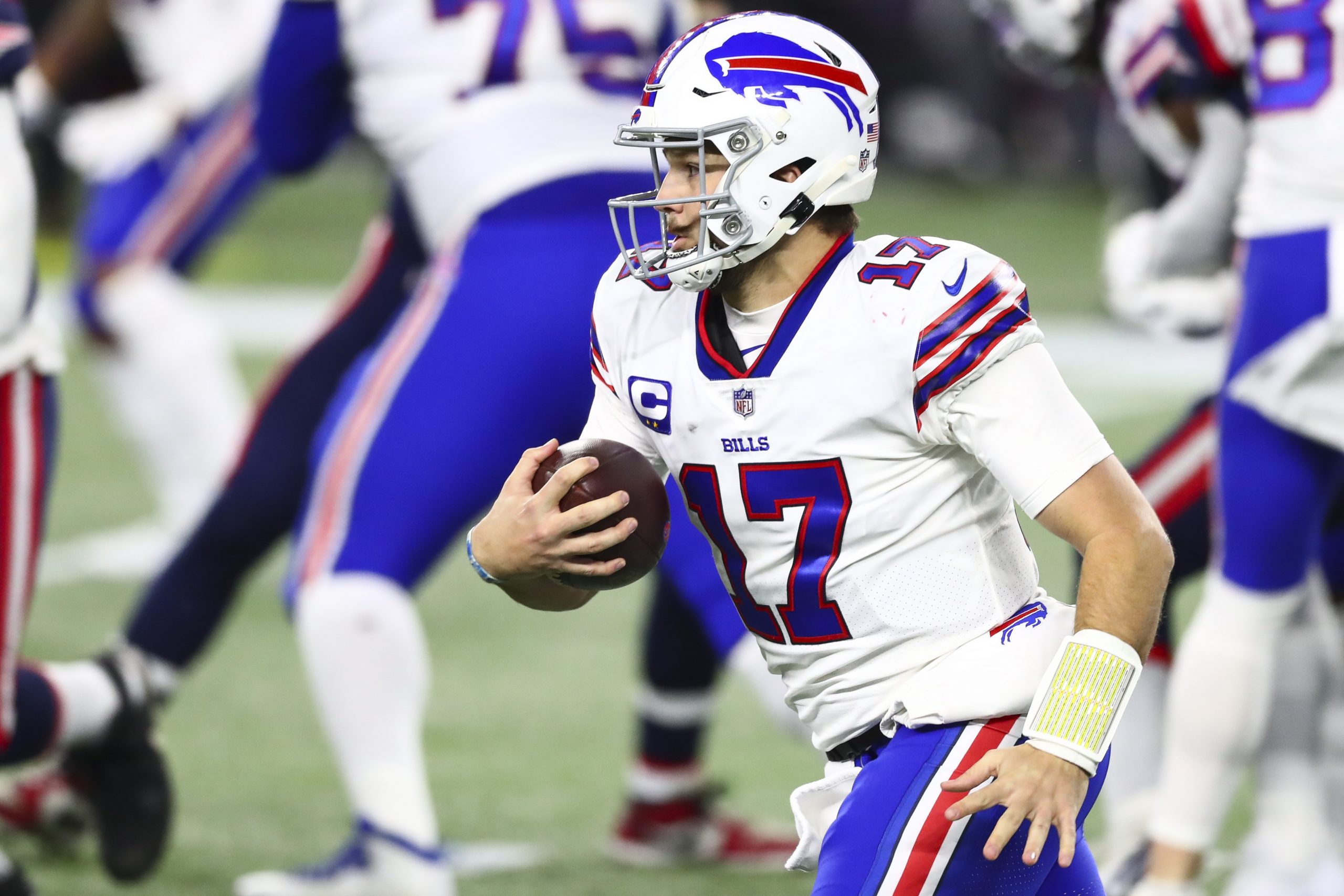 Josh Allen of the Buffalo Bills runs with the ball during a game against the New England Patriots.