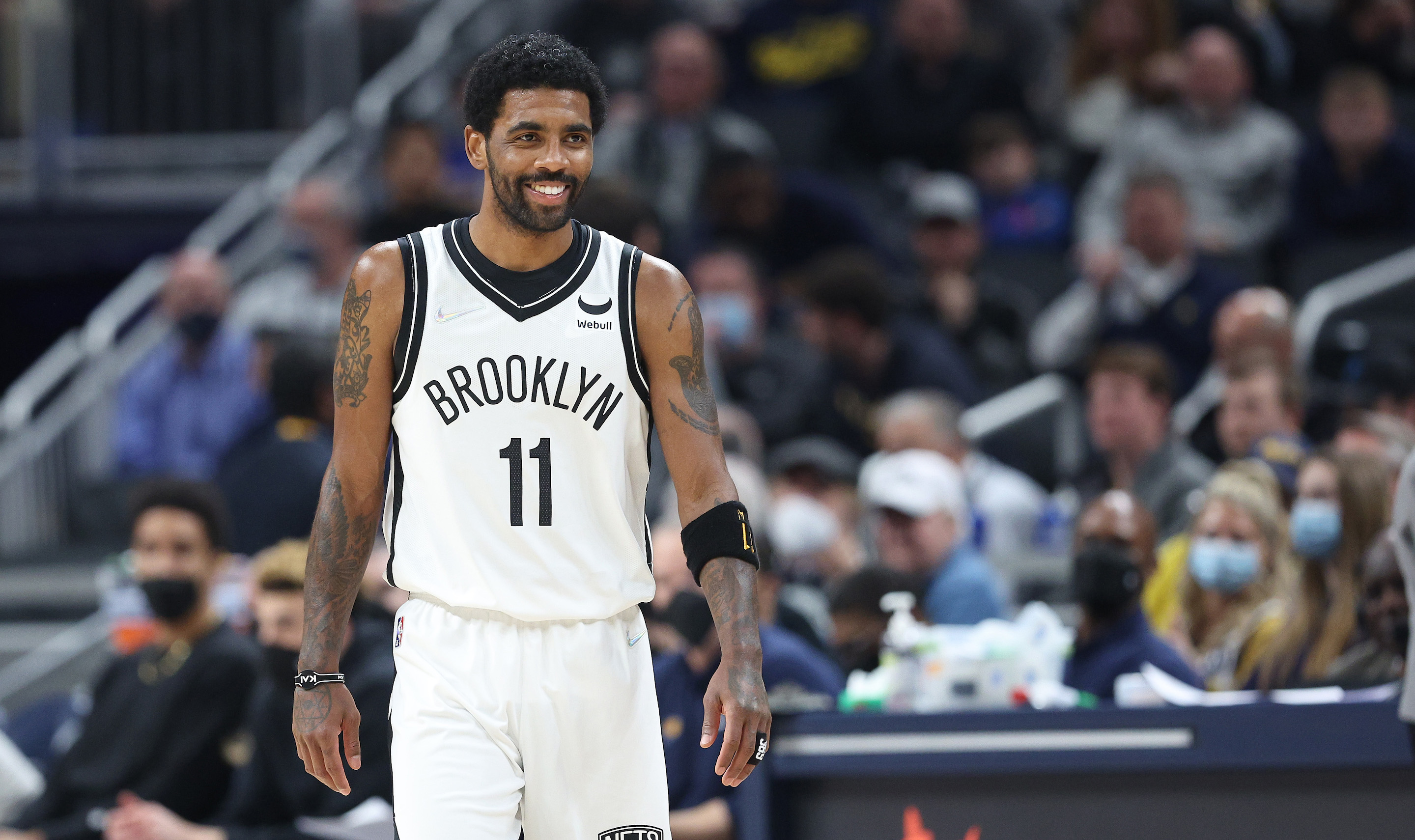 Brooklyn Nets guard Kyrie Irving smiles during an NBA game against the Indiana Pacers