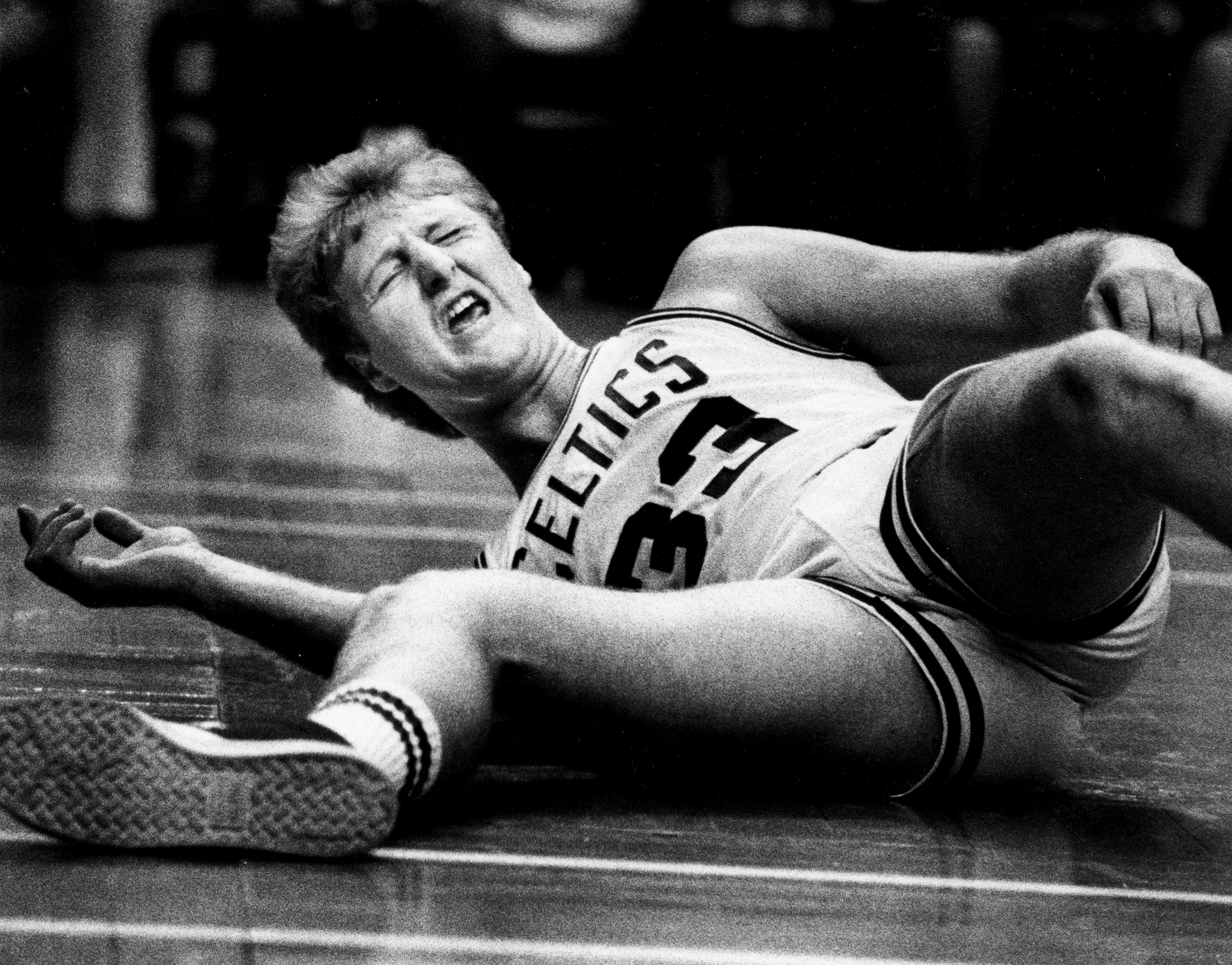 Boston Celtics legend Larry Bird writhes in pain during a game in April 1985