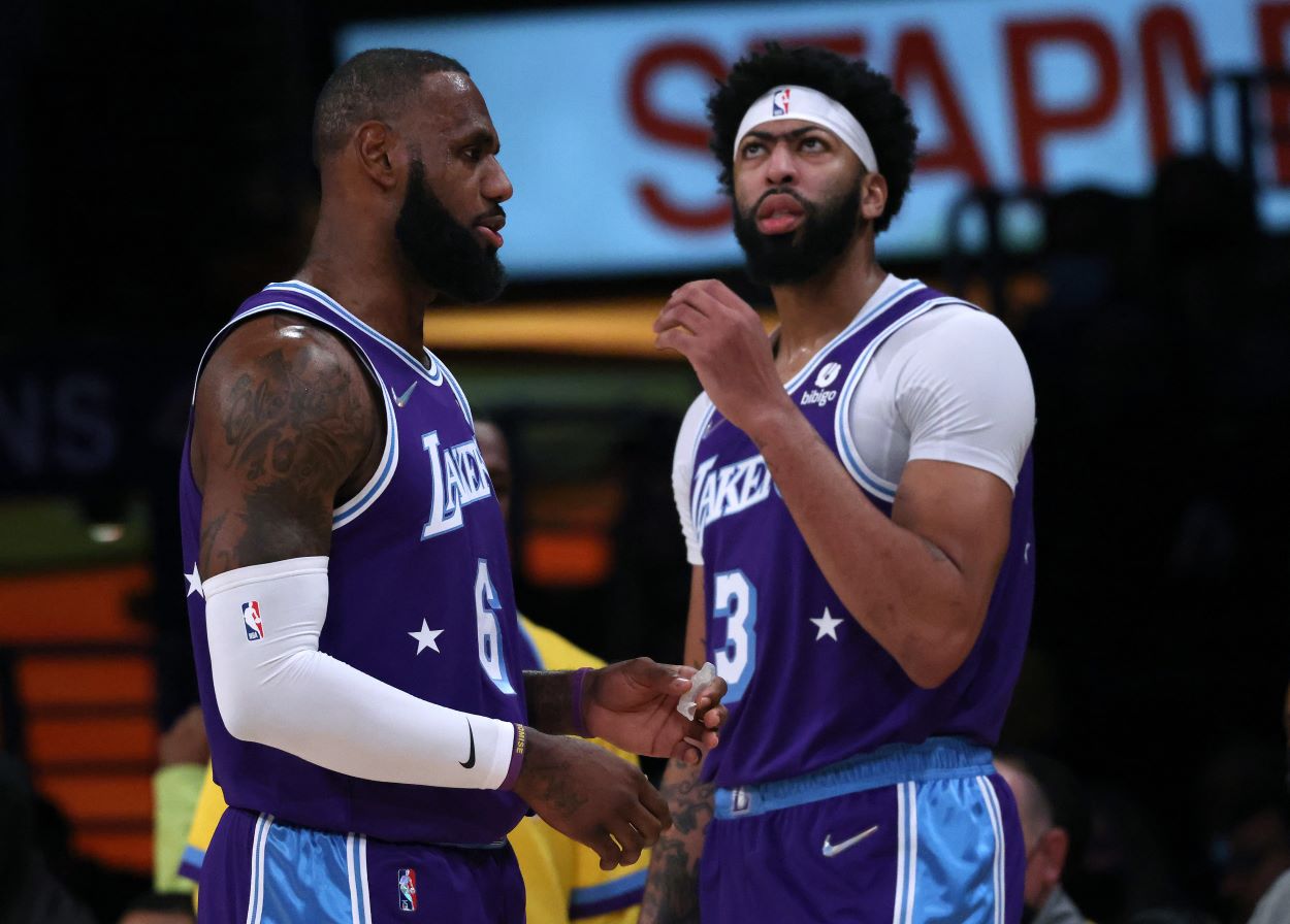 Lakers forwards LeBron James and Anthony Davis interact during an NBA game.