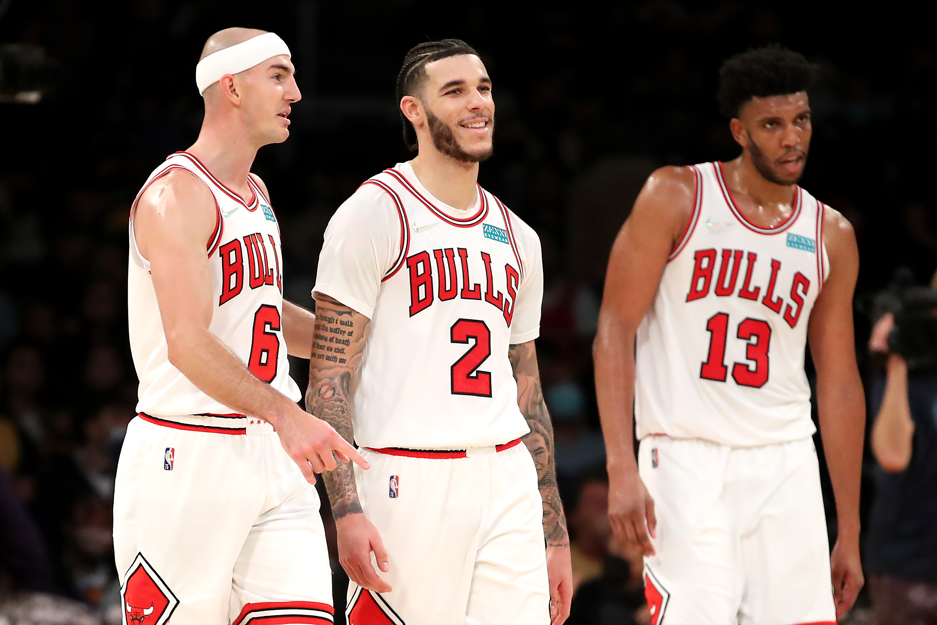Chicago Bulls guards Alex Caruso (L) and Lonzo Ball talk during an NBA game against the Los Angeles Lakers in November 2021