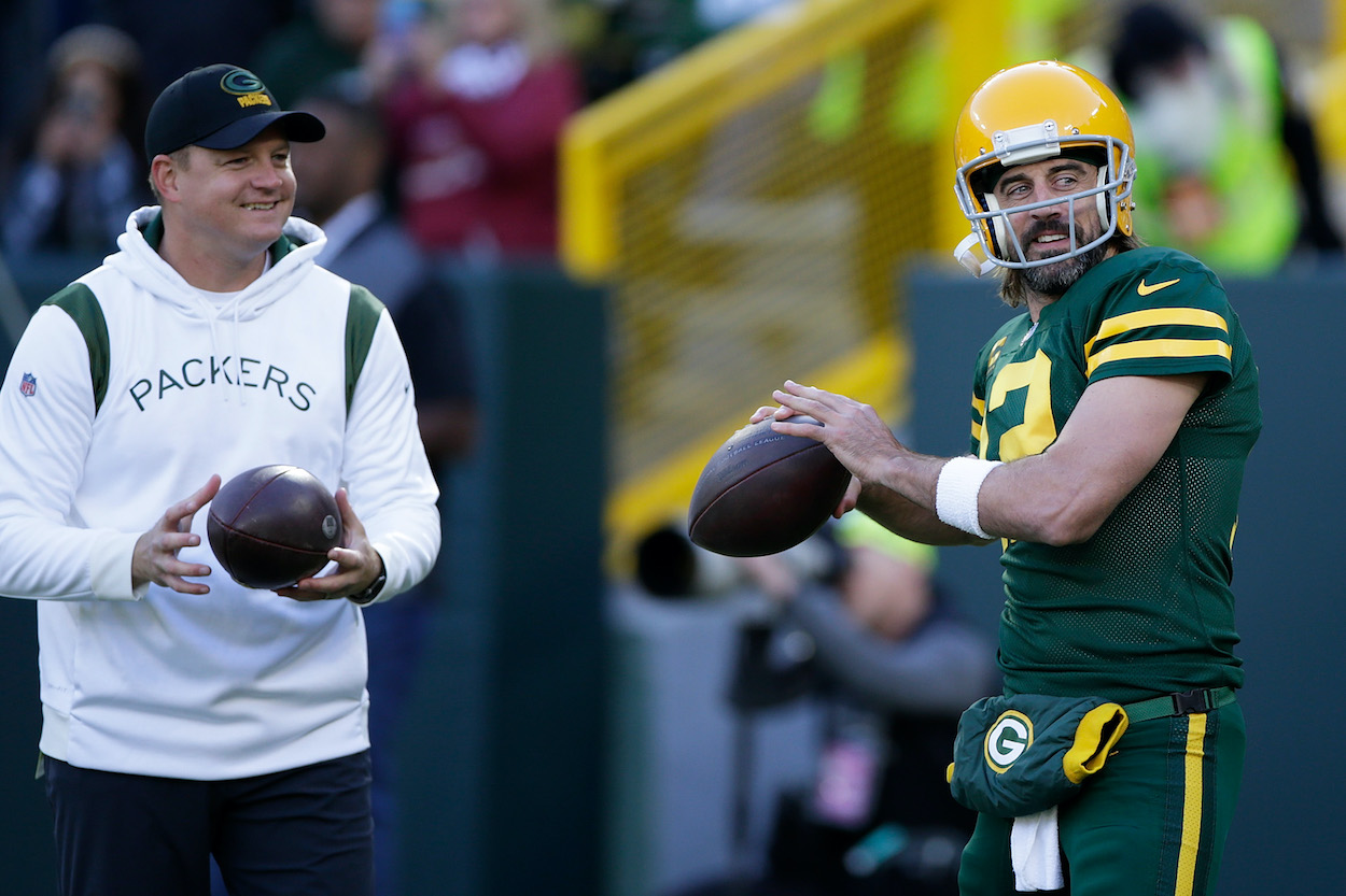 Quarterback coach Luke Getsy looks on as Aaron Rodgers of the Green Bay Packers warms up prior to the game against the Washington Football Team at Lambeau Field on October 24, 2021. The Denver Broncos are interviewinf Getsy and Nathaniel Hackett for their open head coach position.