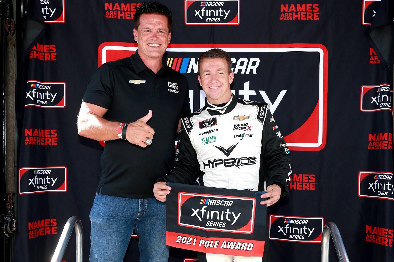 Matt Kaulig, owner of Kaulig Racing, and AJ Allmendinger, driver of the No. 16 Chevrolet, pose for photos after winning the pole award during qualifying for the NASCAR Xfinity Series Pennzoil 150 at the Brickyard at Indianapolis Motor Speedway on Aug. 14, 2021.