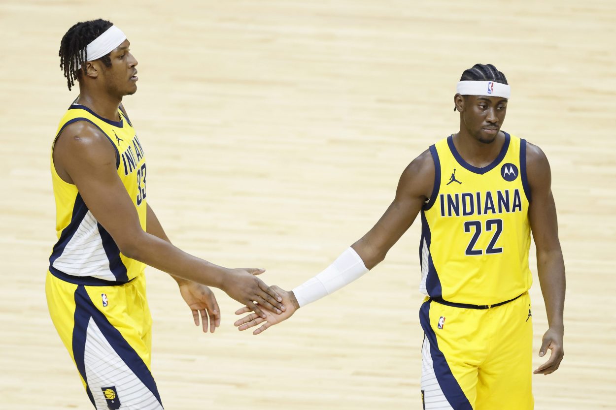 Indiana Pacers teammates Myles Turner and Caris LeVert high-five during an NBA game in March 2021