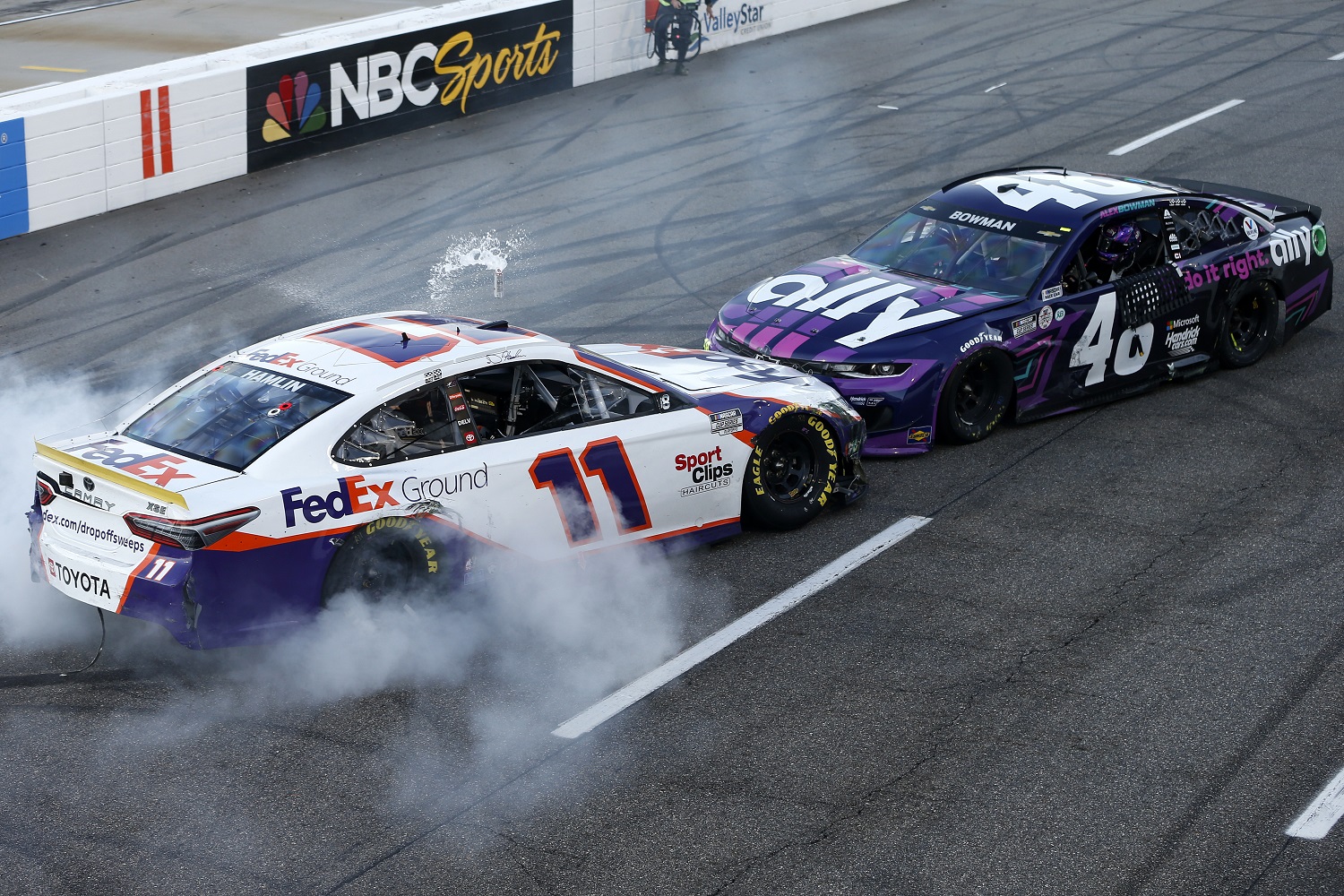 Denny Hamlin, driver of the No. 11 Toyota, impedes Alex Bowman's celebration after winning the NASCAR Cup Series Xfinity 500 at Martinsville Speedway on Oct. 31, 2021.