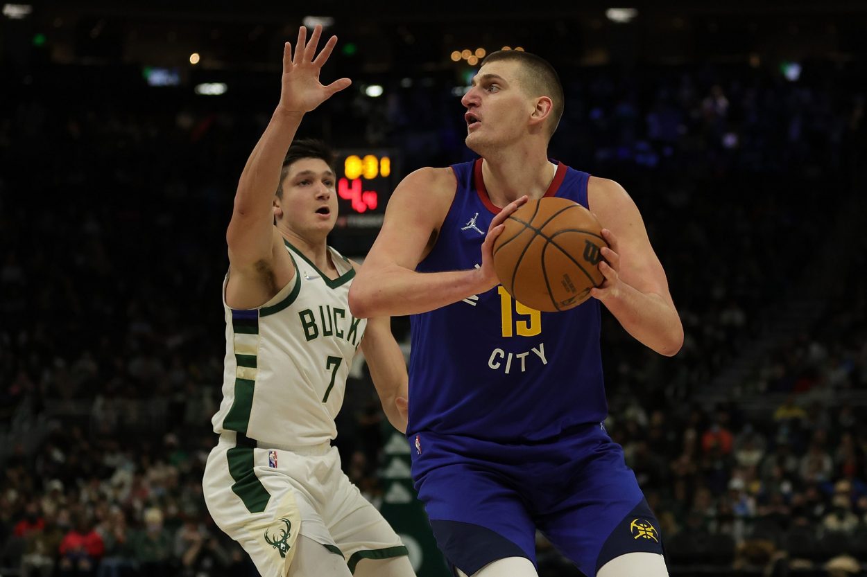 Denver Nuggets star Nikola Jokic shoots over Milwaukee Bucks guard Grayson Allen during an NBA game in January 2022
