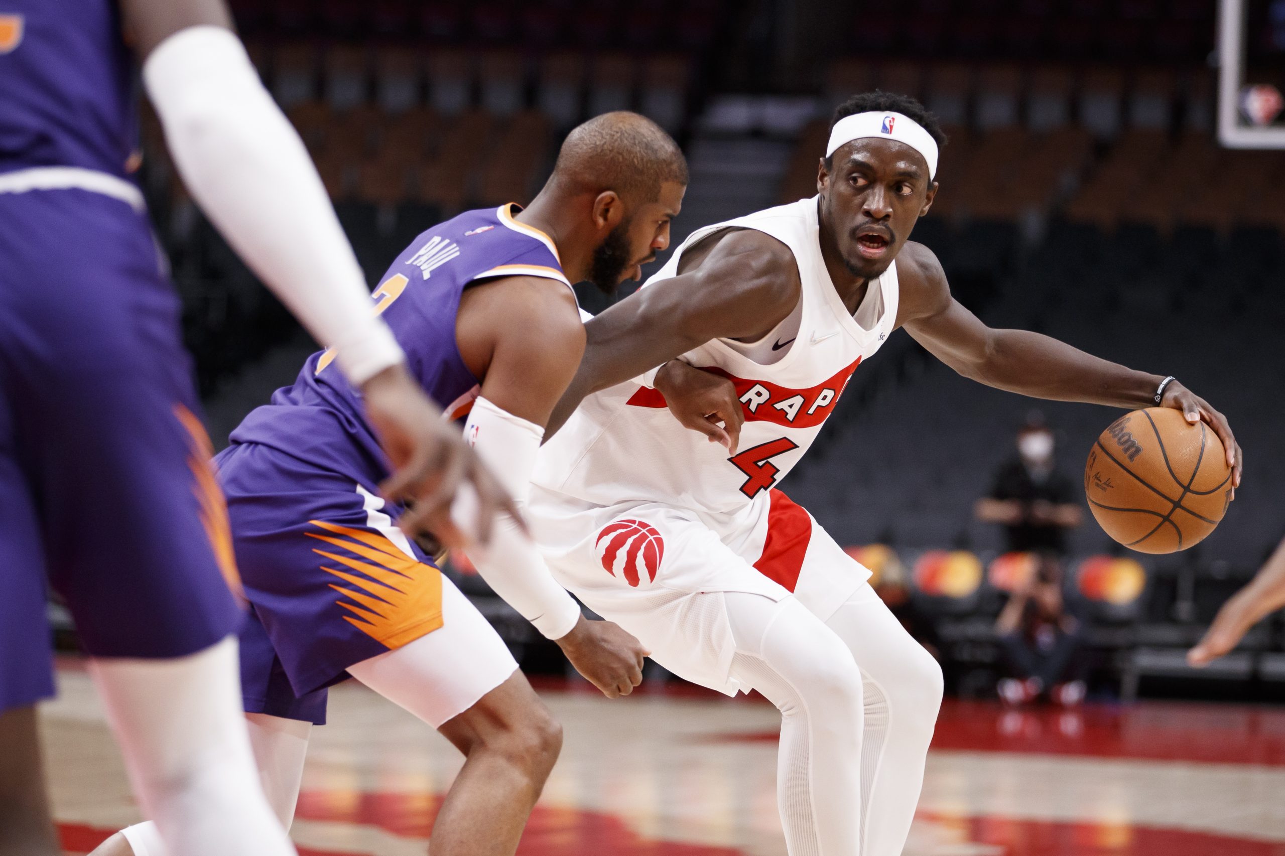 Toronto Raptors standout forward Pascal Siakam battles in the post with Phoenix Suns superrstar point guard Chris Paul during a recent game in Toronto.