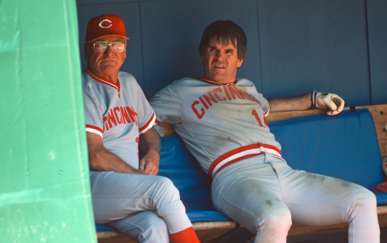 Bench coach George Scherger (L) and player/manager Pete Rose of the Cincinnati Reds look on from the dugout.