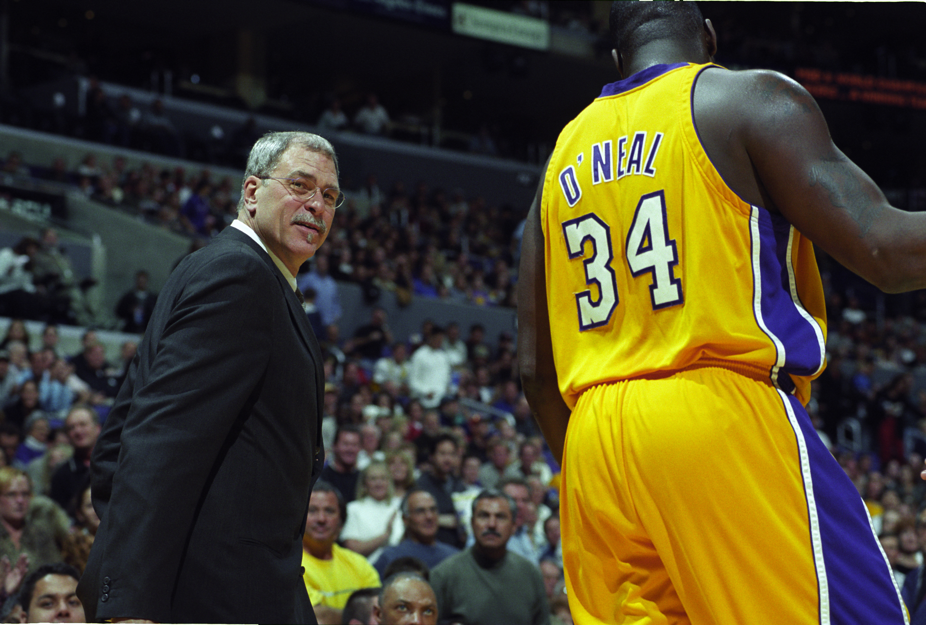 Former Los Angeles Lakers head coach Phil Jackson talks with Shaquille O'Neal