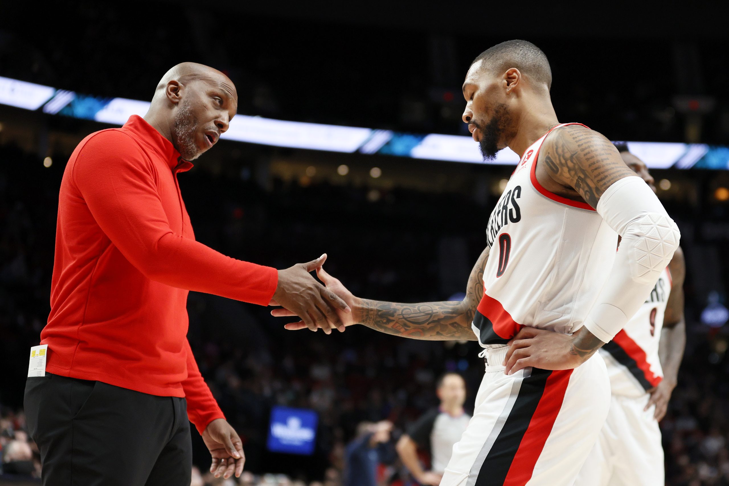 Portland Trail Blazers coach Chauncey Billups congratulates star guard Damian Lillard following a good play in a recent game against the Memphis Grizzlies.