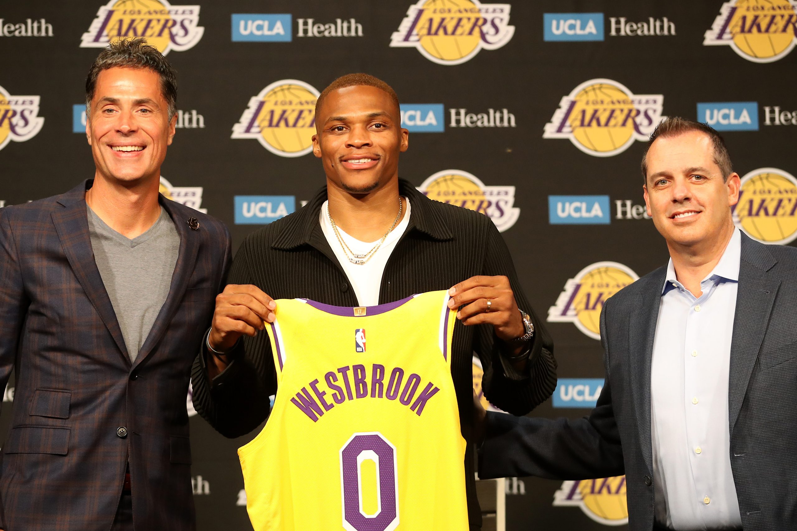 GM Rob Pelinka, Russell Westbrook and head coach Frank Vogel pose at a news conference after the point guard's trade to the franchise becomes official.
