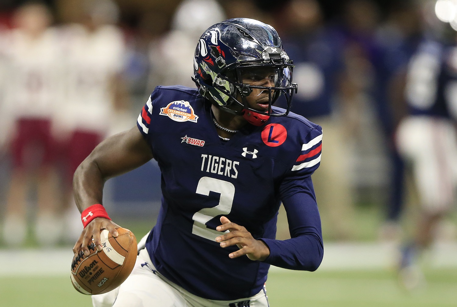 Quarterback Shedeur Sanders of the Jackson State Tigers looks for a receiver during the college football Cricket Celebration Bowl against the South Carolina State Bulldogs on Dec. 18, 2021 at the Mercedes-Benz Stadium in Atlanta, Georgia.