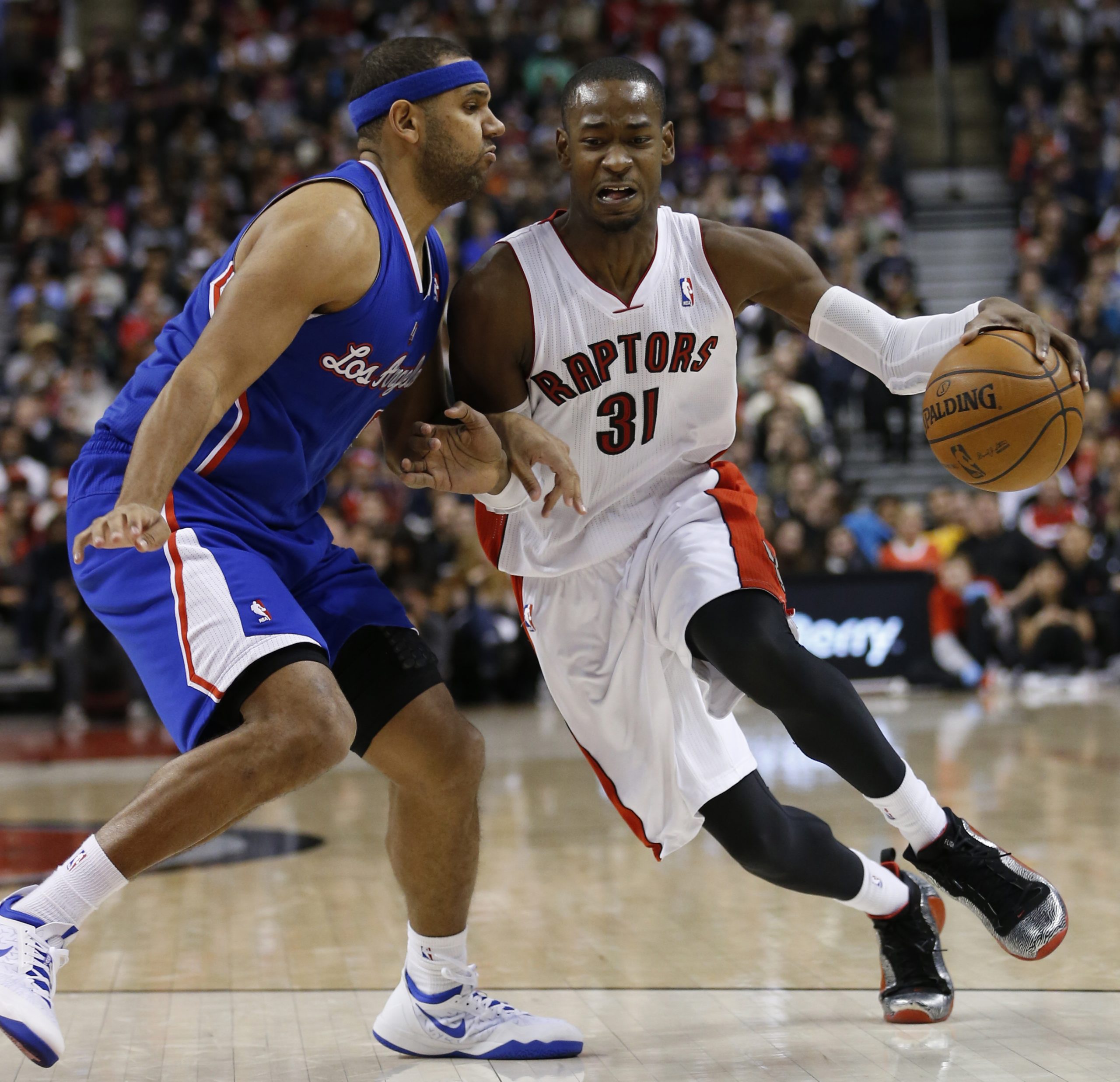 Former Toronto Raptors drives by Los Angeles Clippers forward Jared Dudley on Jan. 25, 2014.