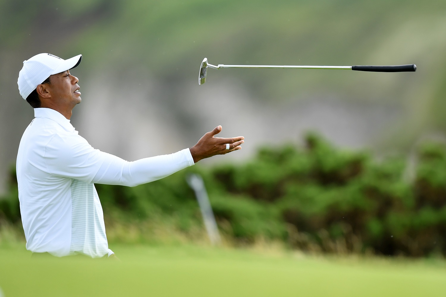 Tiger Woods tosses his club during the second round of the 148th Open Championship held on the Dunluce Links at Royal Portrush Golf Club on July 19, 2019.