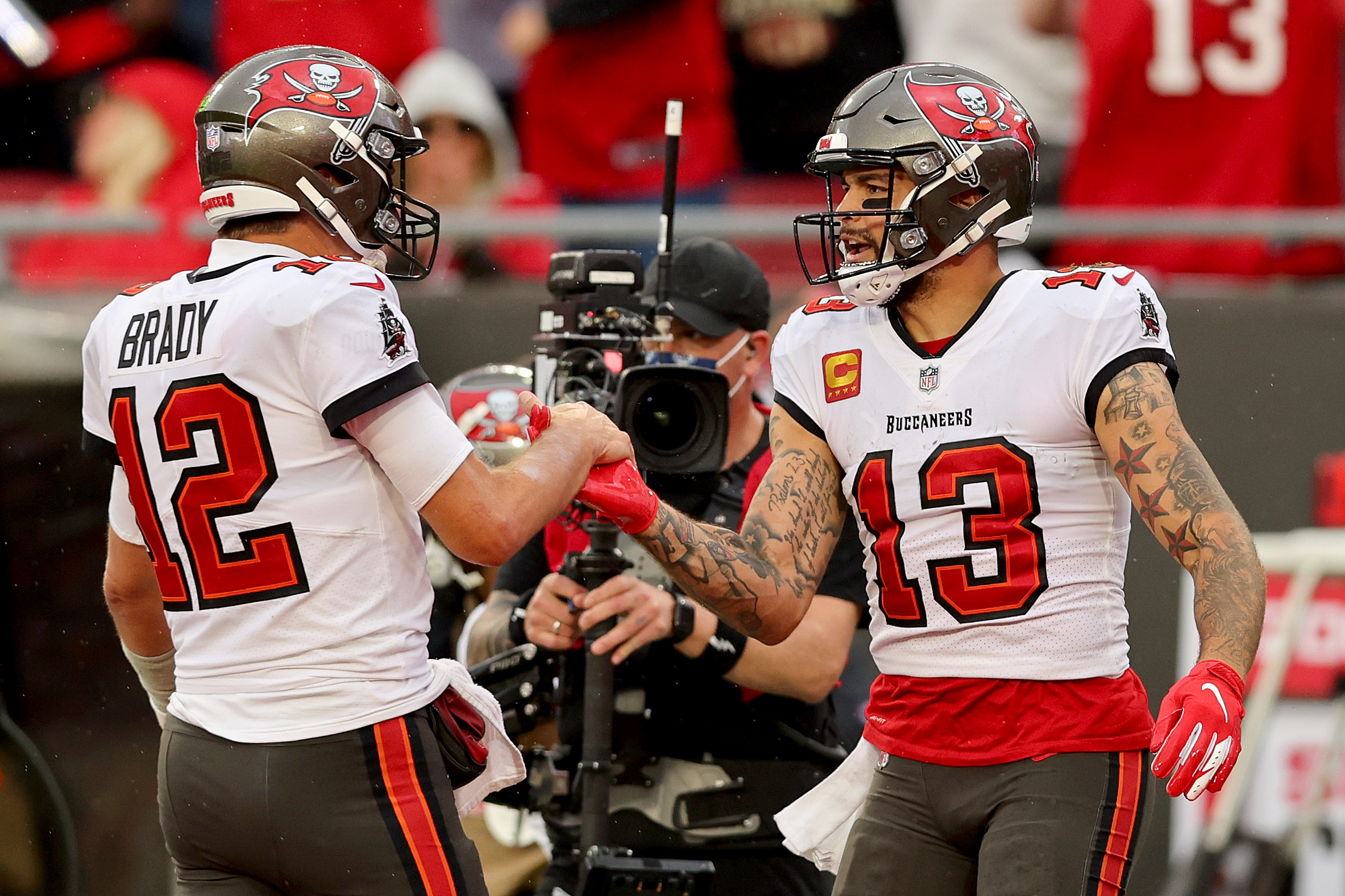 Mike Evans #13 of the Tampa Bay Buccaneers celebrates with Tom Brady #12 after scoring a touchdown against the Philadelphia Eagles.