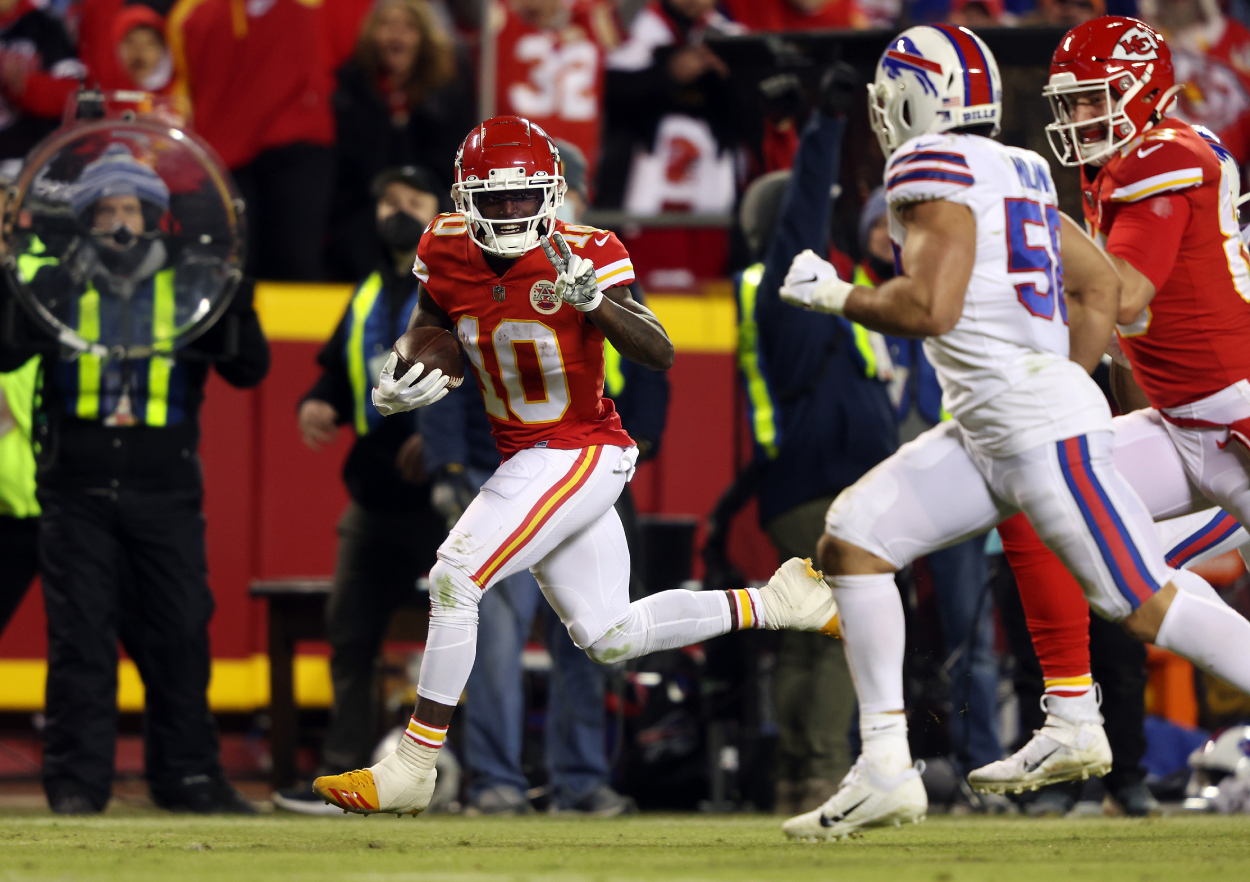 Wide receiver Tyreek Hill of the Kansas City Chiefs flashes a peace sign toward outside linebacker Matt Milano of the Buffalo Bills.