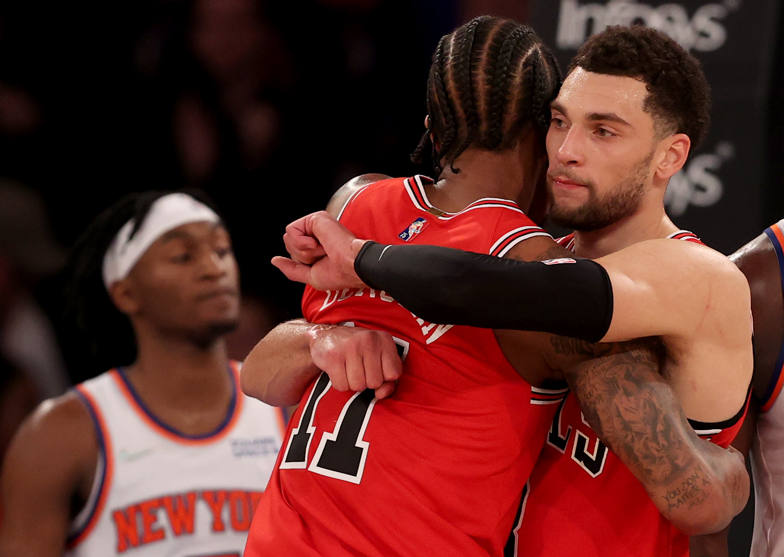 Chicago Bulls stars Zach LaVine and DeMar DeRozan embrace during a December 2021 win over the New York Knicks