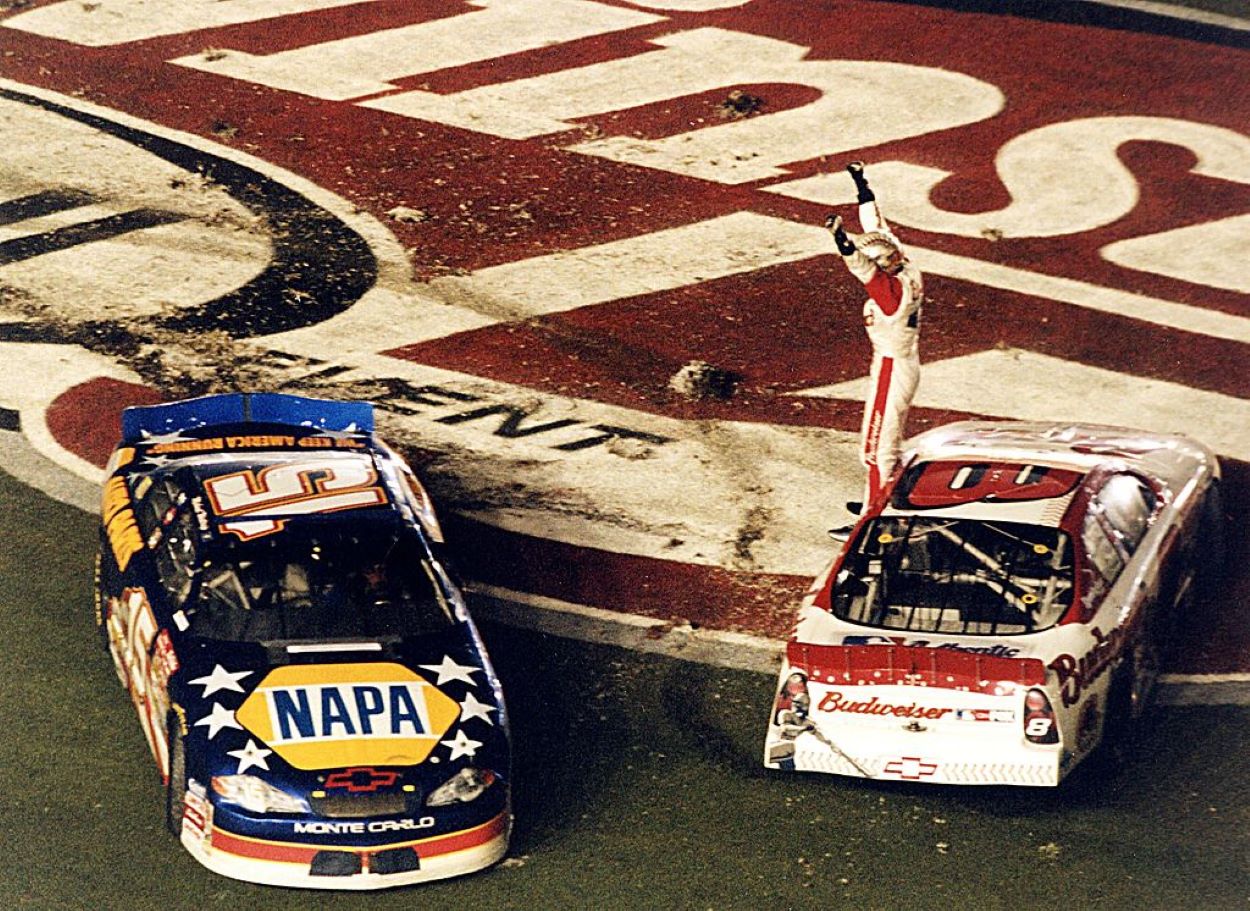NASCAR Winston Cup driver Dale Earnhardt Jr. stands on his car and celebrates his first career victory during The Pepsi 400. He was joined by teammate Michael Waltrip on the infield grass