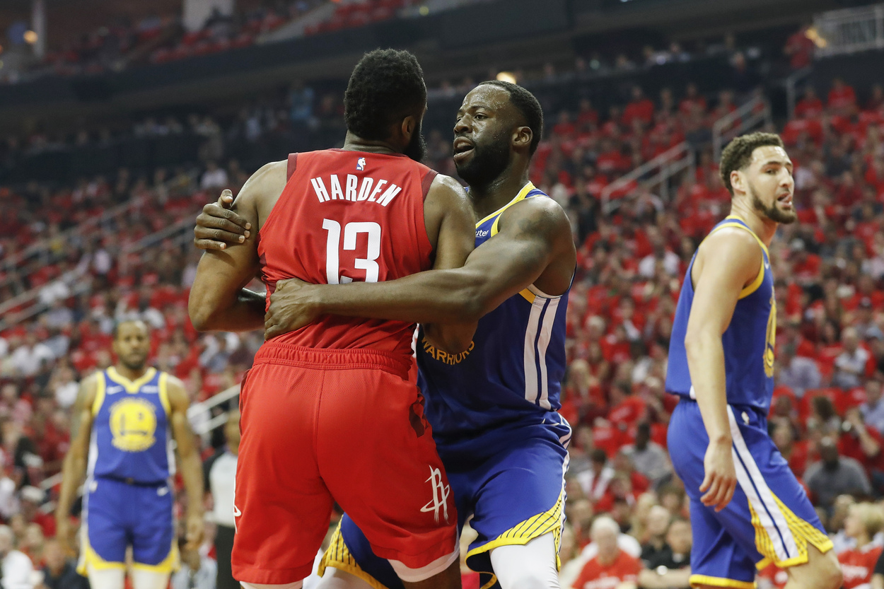 Golden State Warriors forward Draymond Green fouls Houston Rockets guard James Harden.